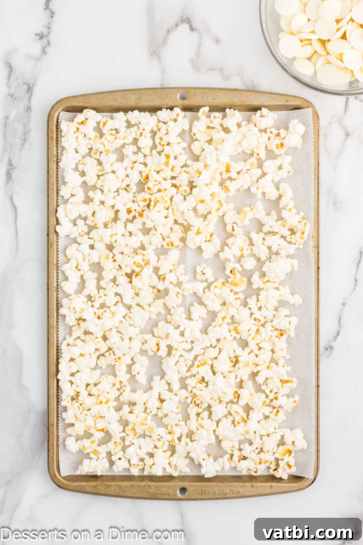 Velvet Chocolate Popcorn 4 Popcorn spread out on a baking sheet.