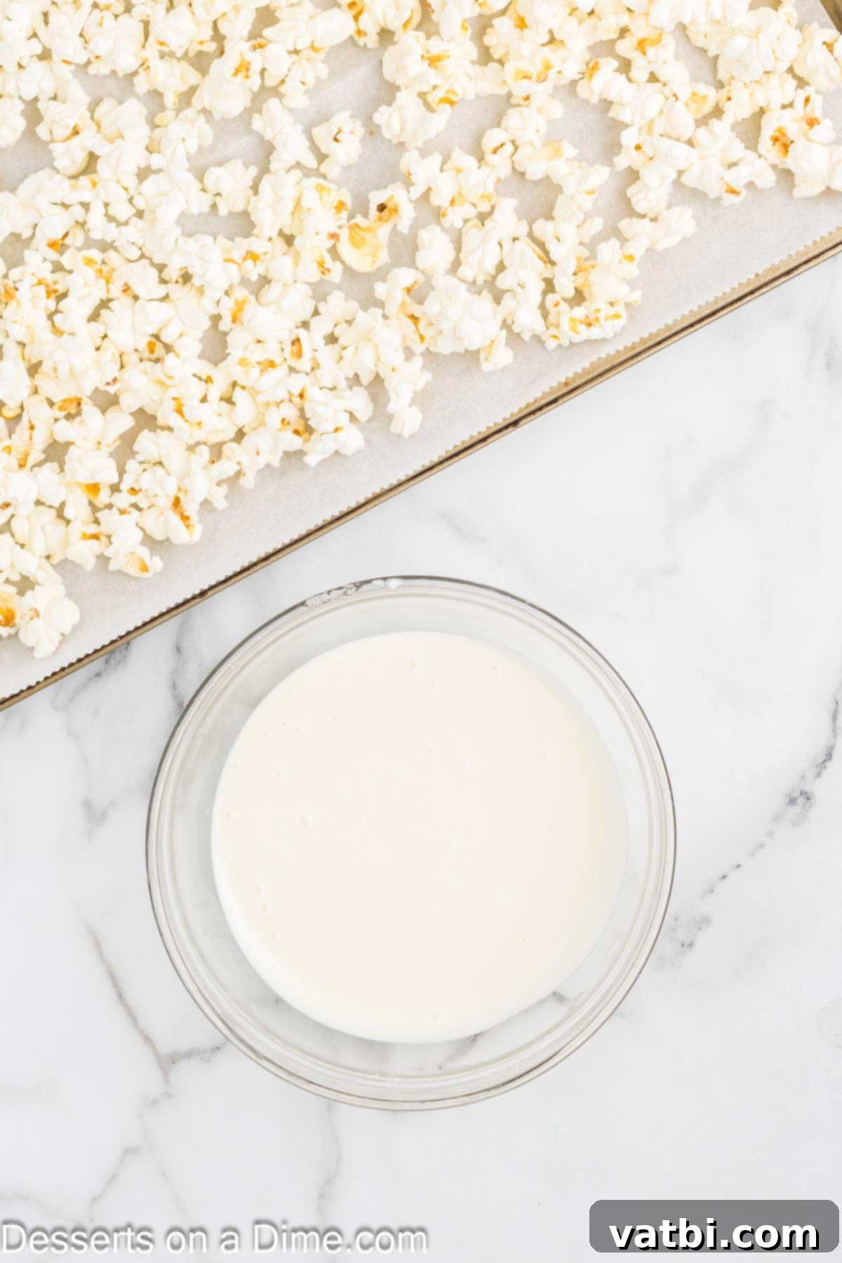 Velvet Chocolate Popcorn 5 White chocolate melted in a bowl.