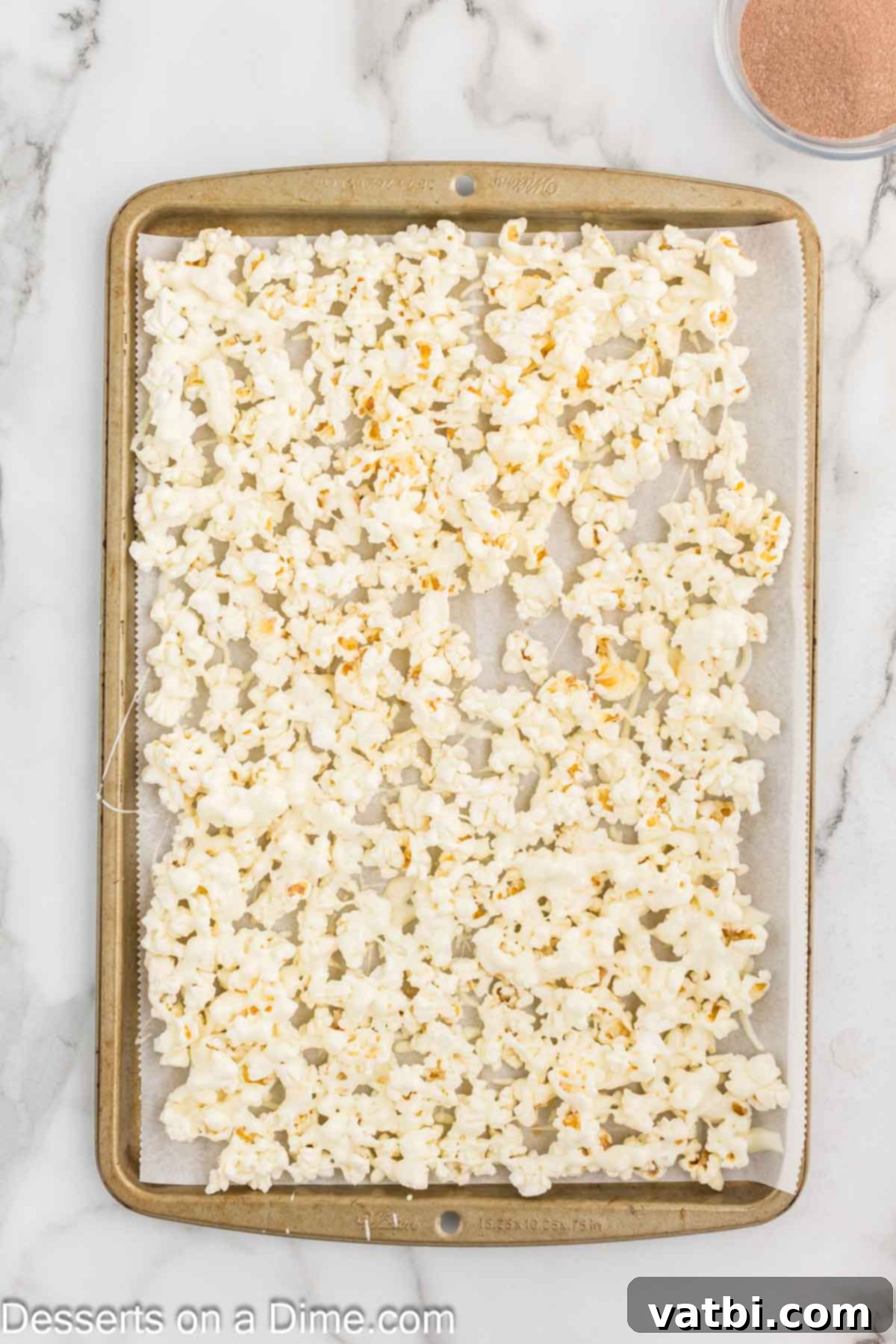 Velvet Chocolate Popcorn 6 White chocolate drizzled on popcorn.