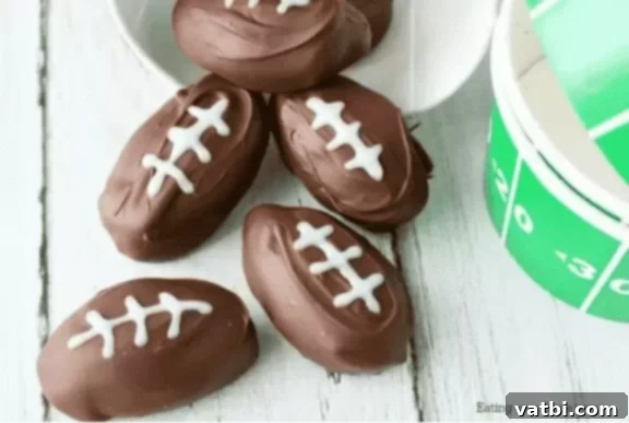 55 Winning Super Bowl Desserts 3 Football shaped chocolate peanut butter balls with white laces.