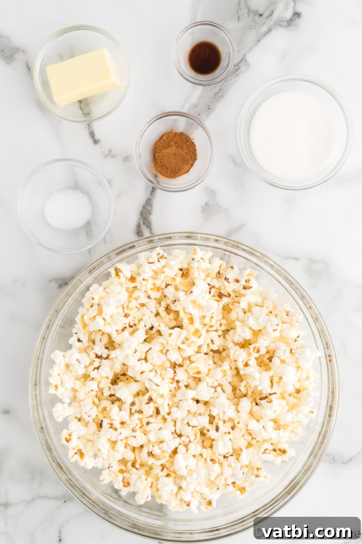 Irresistible Cinnamon Sugar Popcorn 3 Essential ingredients for gourmet cinnamon sugar popcorn: fluffy popped popcorn, rich butter, fragrant vanilla extract, aromatic ground cinnamon, and sparkling granulated sugar.