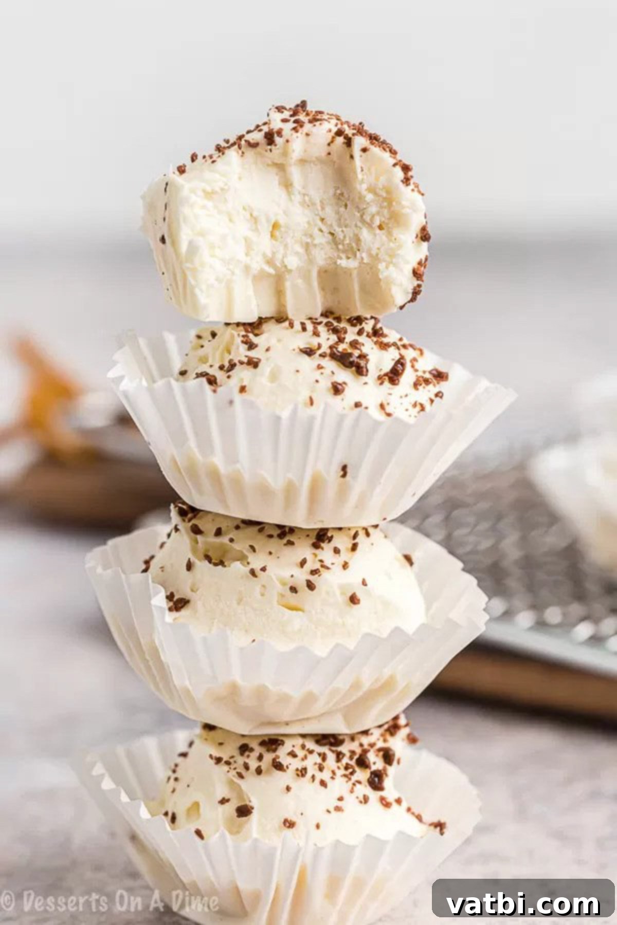 Keto cheesecake fat bomb recipe is a game changer. You can enjoy decadent cheesecake that is keto friendly without any guilt. Decadent Keto Cheesecake Fat Bombs stacked in cupcake liners, ready to enjoy.