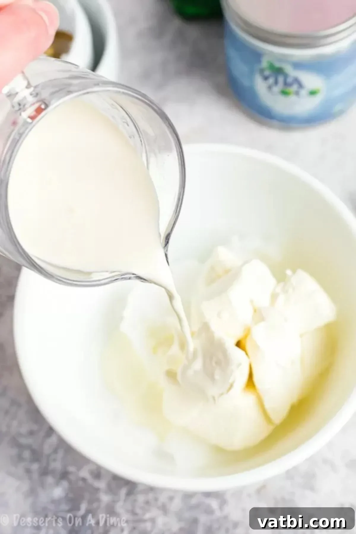 Decadent Keto Cheesecake Fat Bombs 2 Mixing softened cream cheese, butter, heavy cream, and erythritol in a bowl for a smooth Keto Cheesecake Fat Bomb batter.