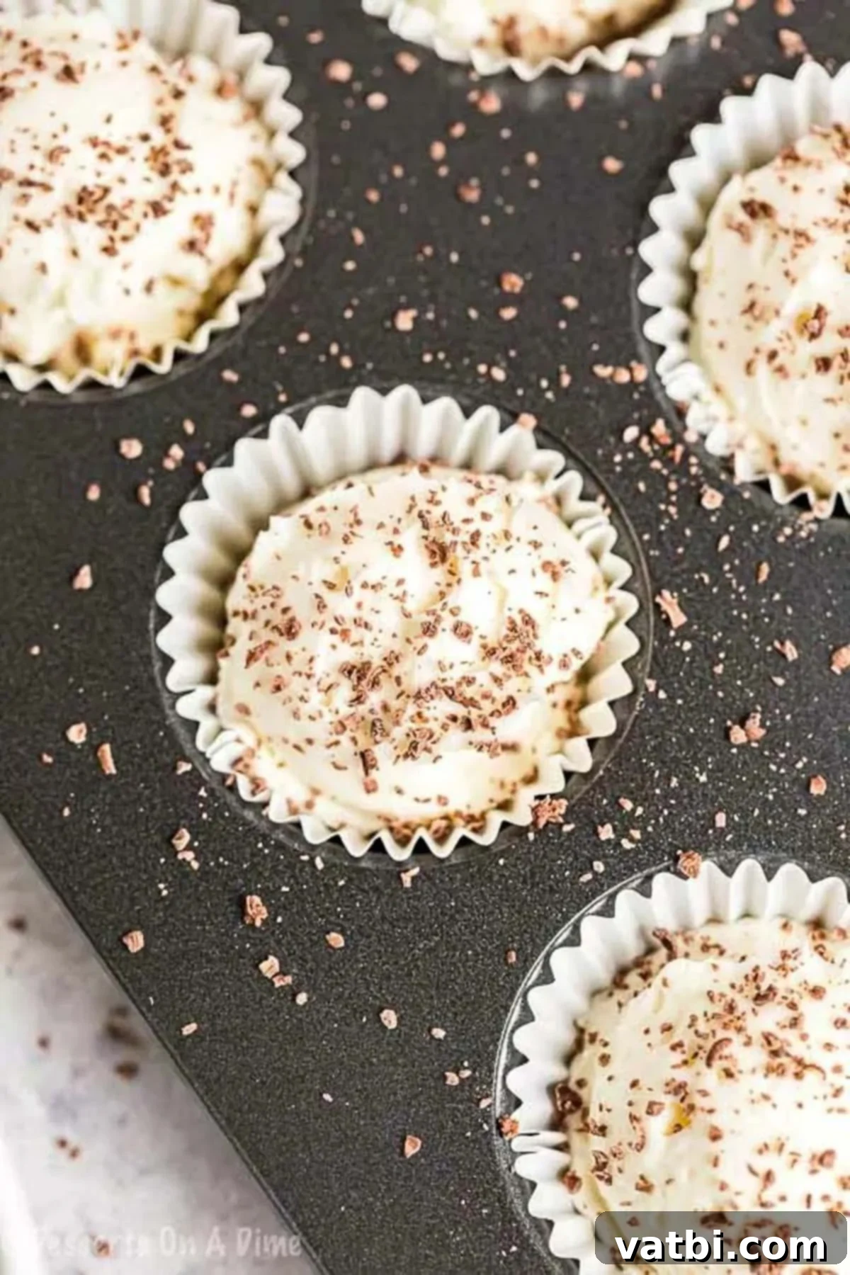 Decadent Keto Cheesecake Fat Bombs 5 Chilled Keto Cheesecake Fat Bombs set in cupcake liners within a muffin pan, perfectly portioned.