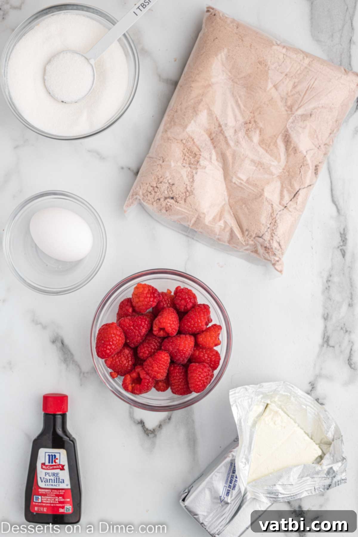Ruby Swirl Raspberry Cheesecake Brownies 3 Ingredients for Raspberry Cheesecake Brownies: brownie mix, softened cream cheese, egg, vanilla extract, granulated sugar, fresh raspberries