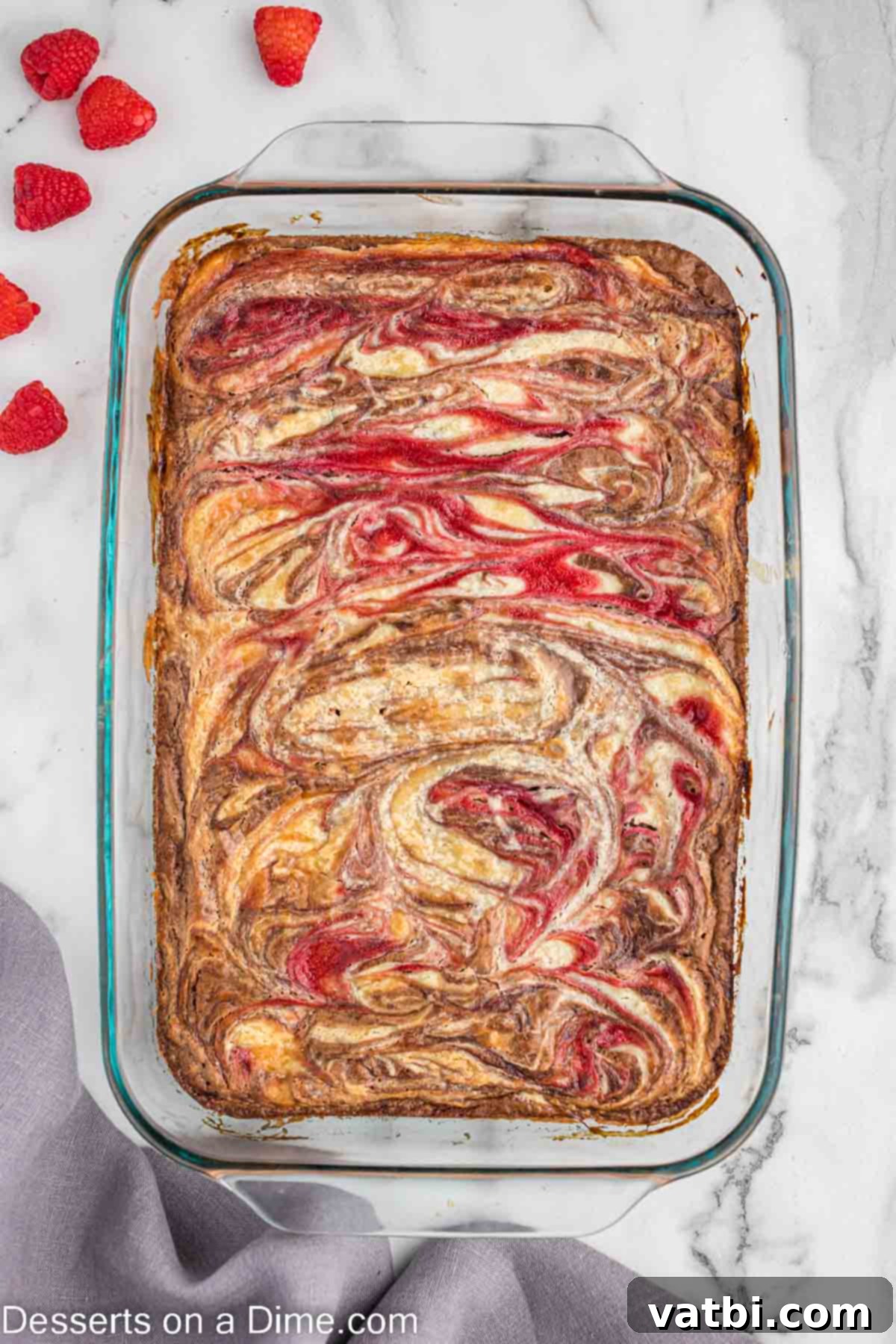 Ruby Swirl Raspberry Cheesecake Brownies 9 A perfectly baked Raspberry Cheesecake Brownie with golden-brown edges and visible swirls
