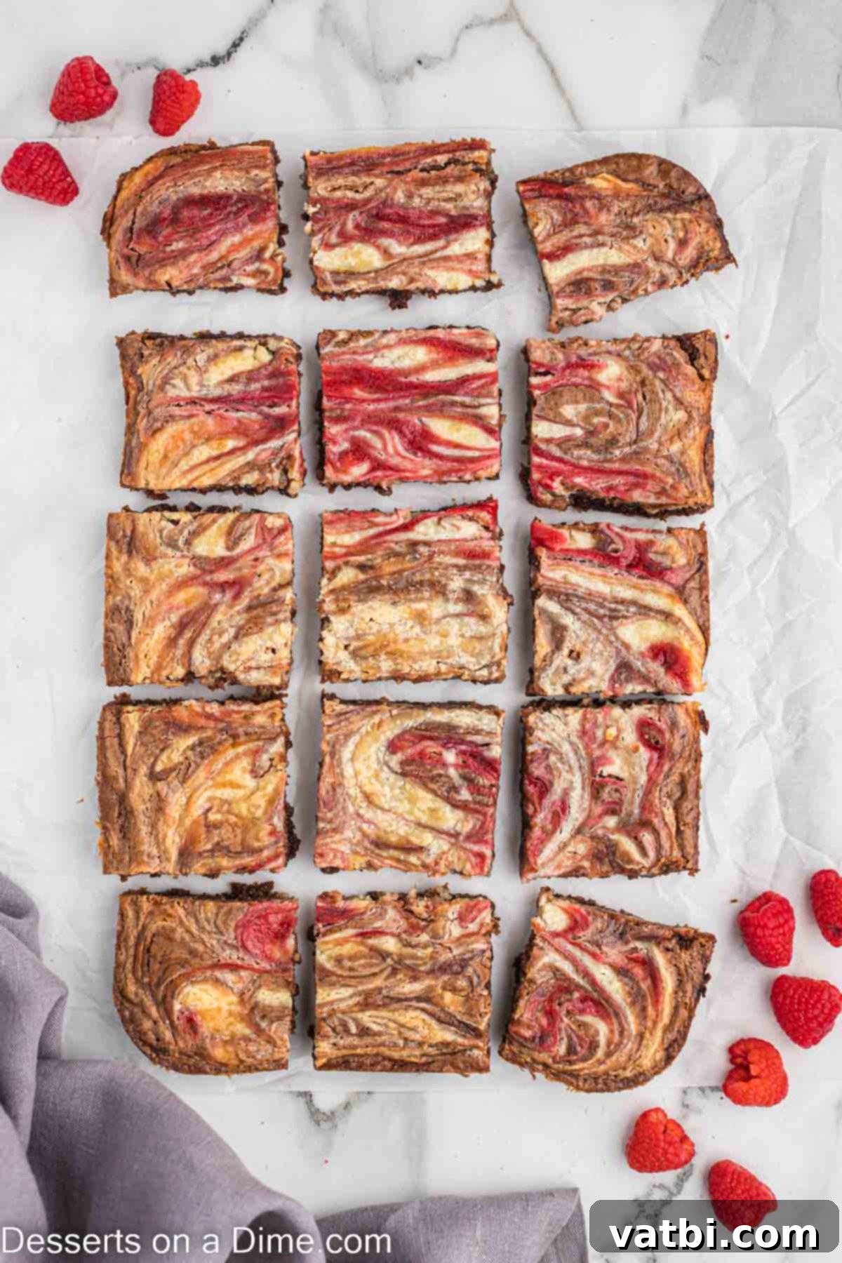 Ruby Swirl Raspberry Cheesecake Brownies 10 Perfectly cut Raspberry Cheesecake Brownies arranged in neat squares