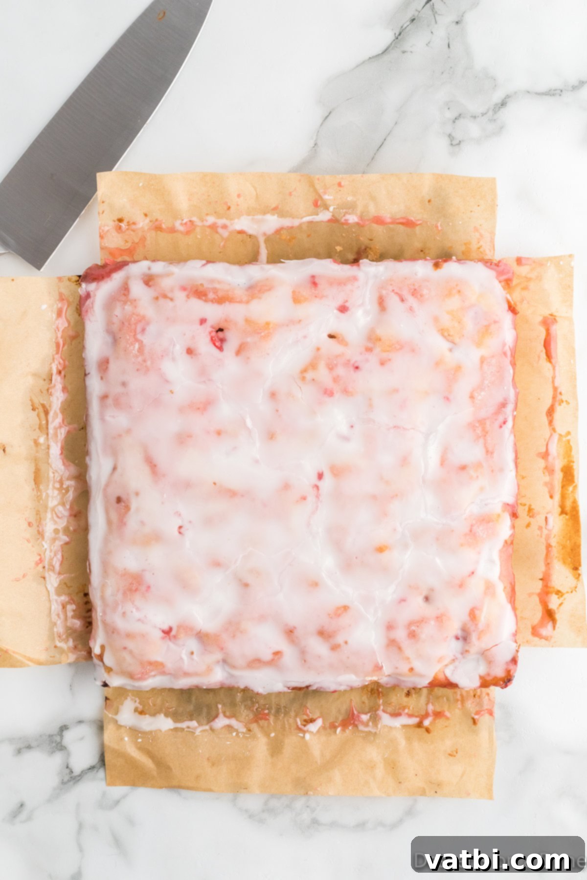 Zesty Strawberry Lemon Blondie Delight 13 Glazed blondies in the pan, with the glaze set and ready to be sliced.