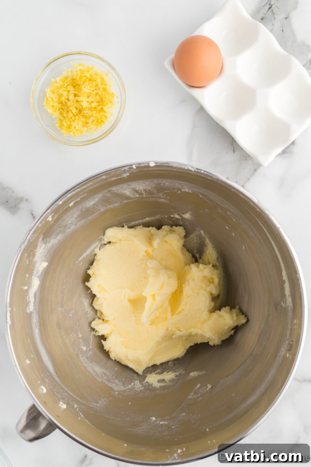 Zesty Strawberry Lemon Blondie Delight 5 Mixing bowl with butter and granulated sugar being creamed together.