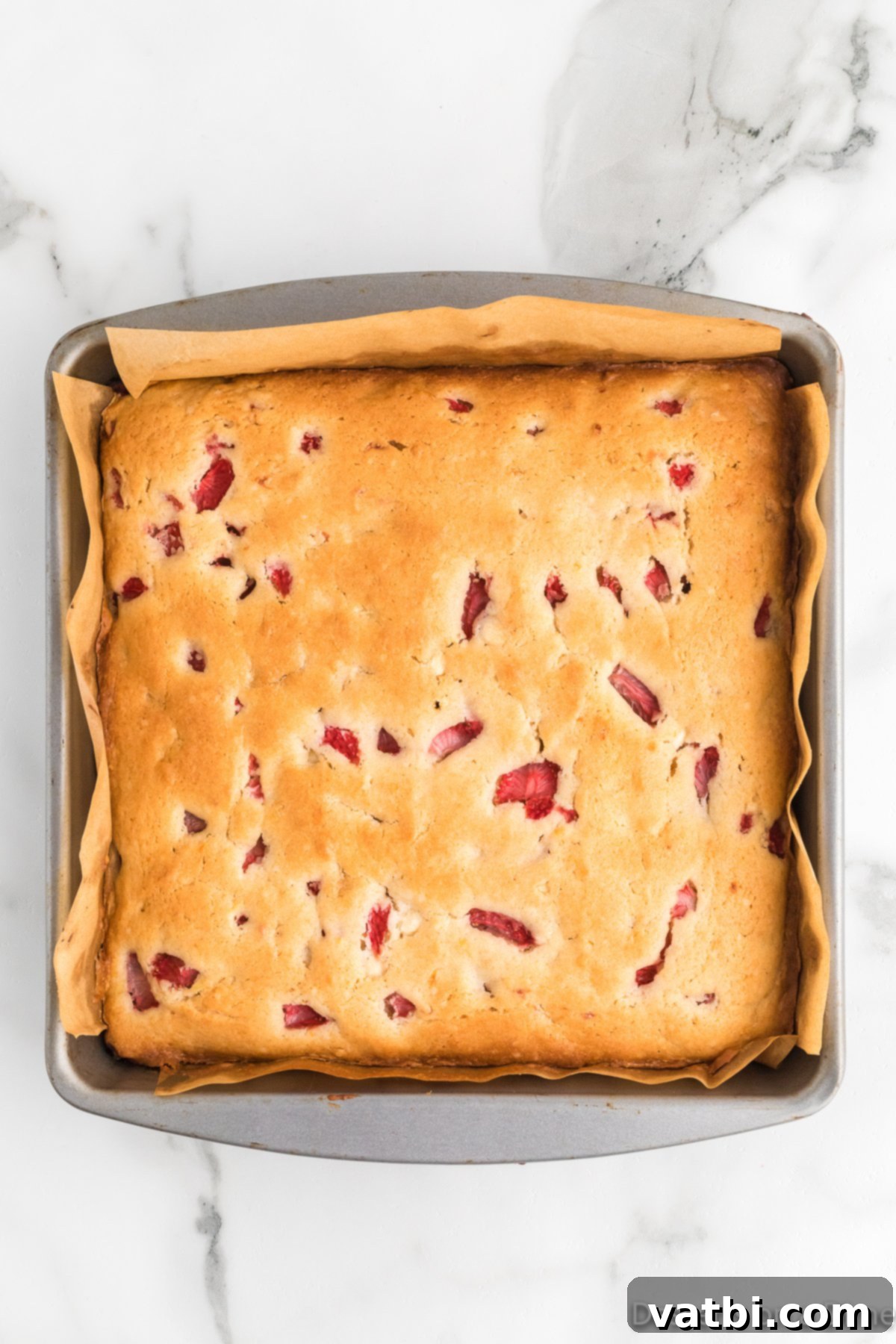 Zesty Strawberry Lemon Blondie Delight 10 Baked blondies in the pan, cooling on a wire rack.