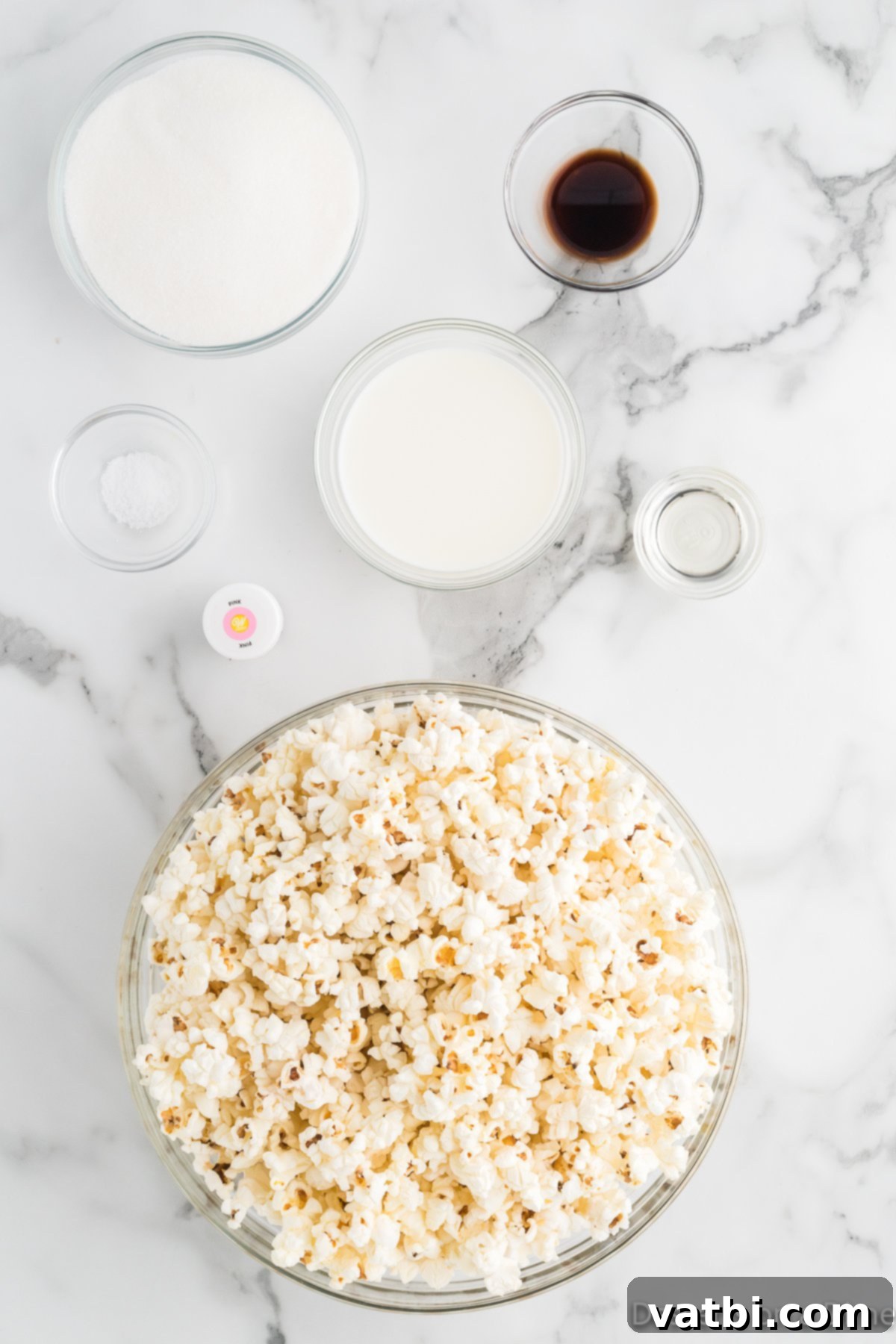 Blush Bites 3 Ingredients for Pink Popcorn: popped popcorn, whole milk, vanilla extract, granulated sugar, corn syrup, salt, and pink food coloring.