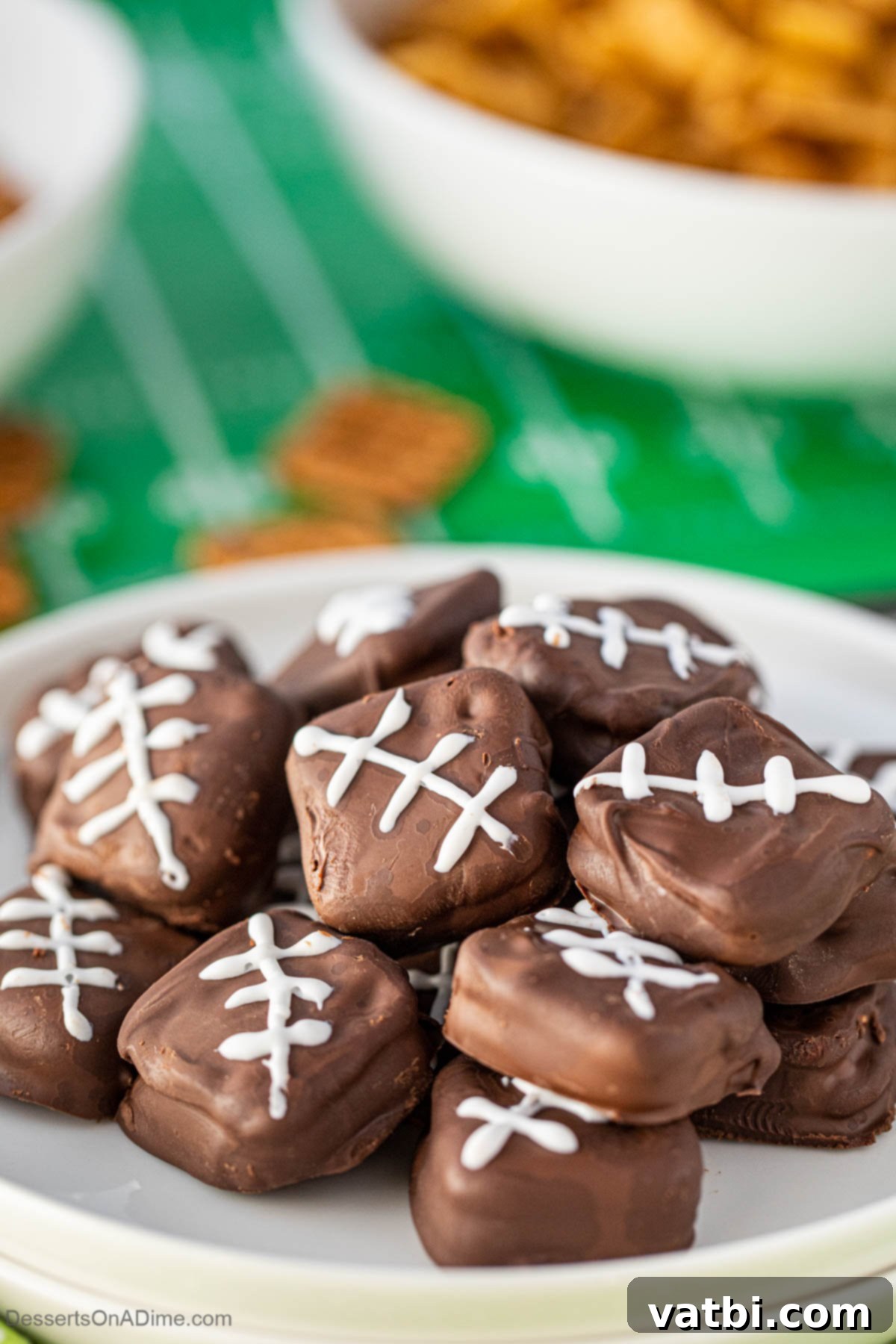 A festive platter of Football Chocolate Covered Pretzel Cookies, shaped like mini footballs, ready for game day.
