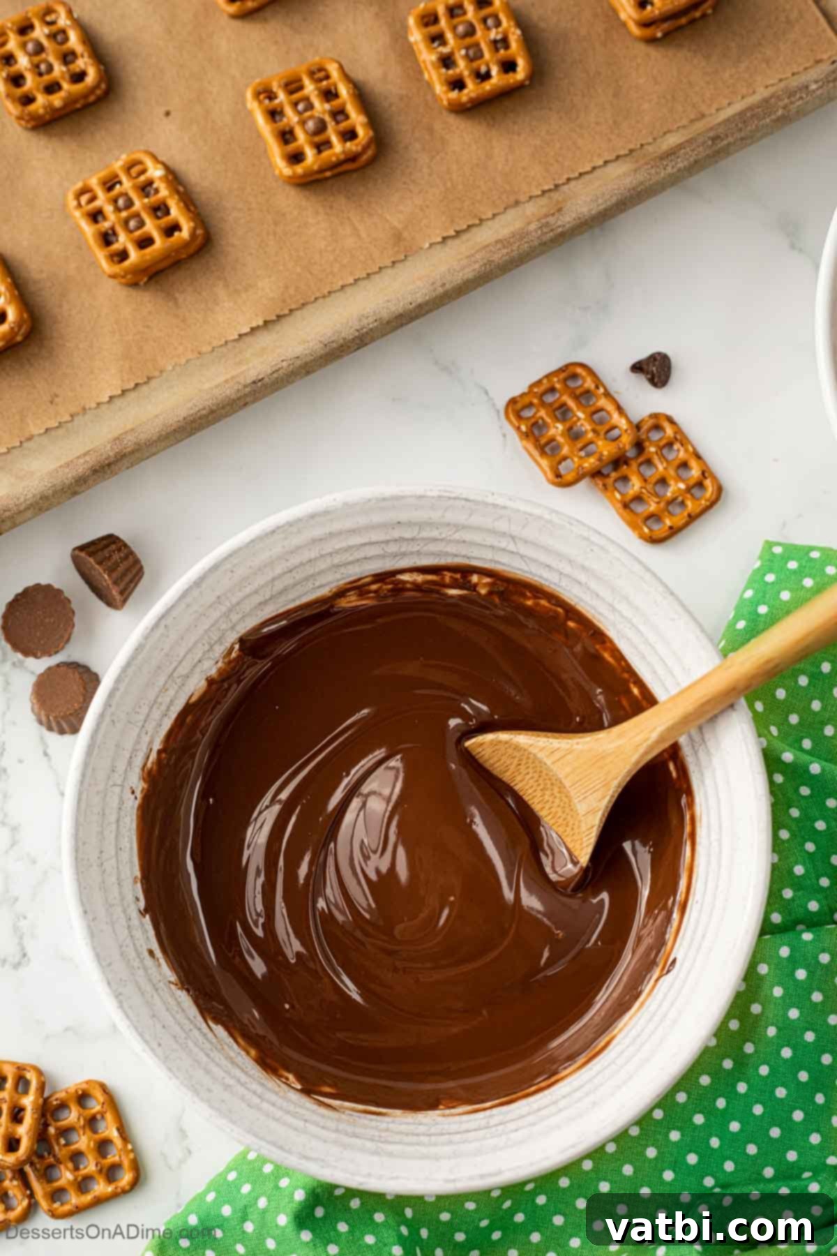 A microwave-safe bowl filled with melted semi-sweet chocolate chips and coconut oil, smooth and ready for dipping.