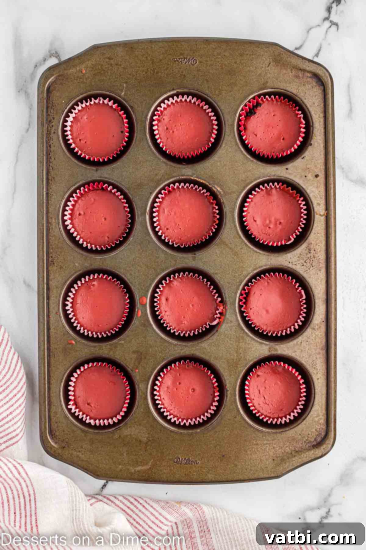 Baked mini cheesecakes cooling in the muffin pan.