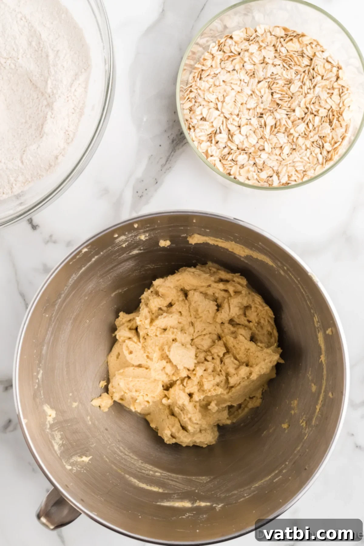 Loaded Cowboy Cookies 6 Wet and dry cookie ingredients are being combined in a large mixing bowl.