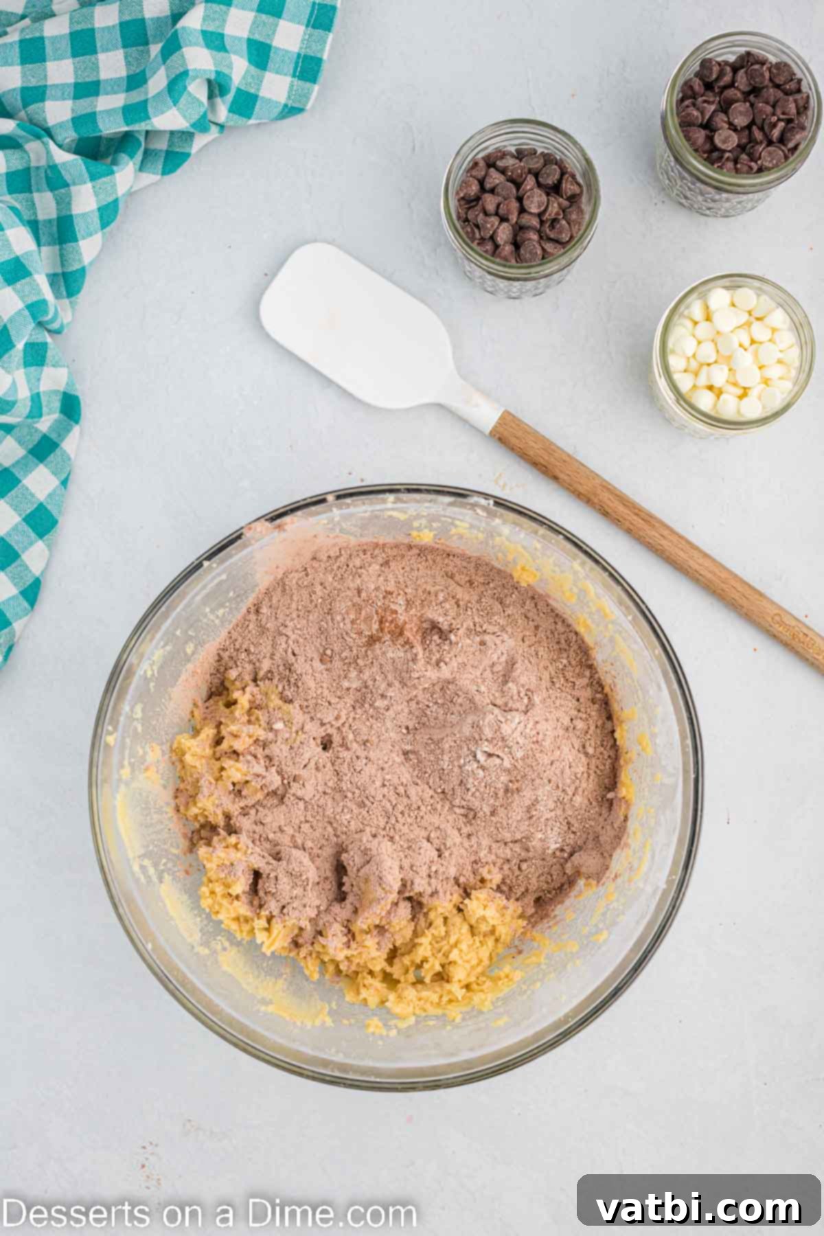 Decadent Triple Chocolate Cookies 7 Wet and dry ingredients combined in a bowl, forming a dark chocolate cookie dough.