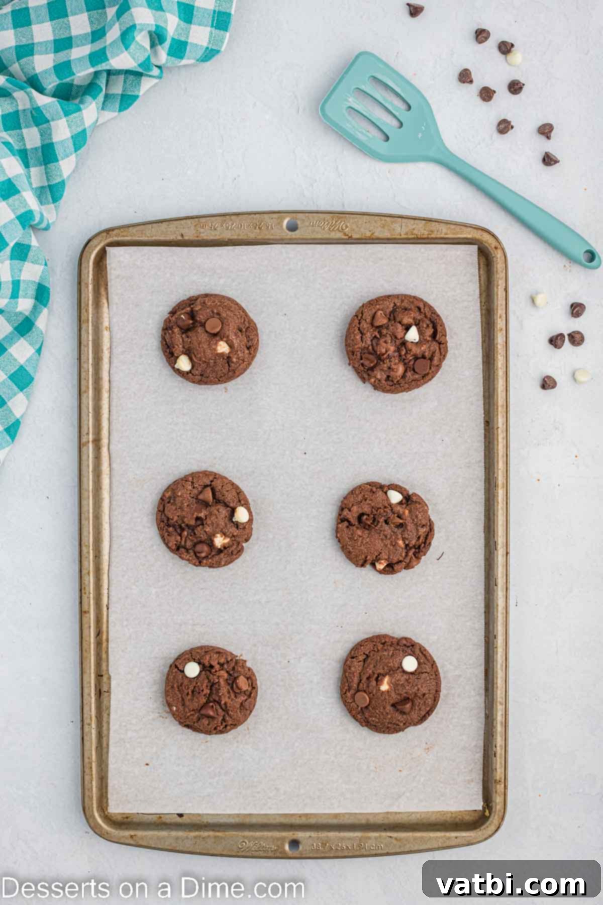 Decadent Triple Chocolate Cookies 10 Baked triple chocolate cookies resting on the baking sheet immediately after coming out of the oven.