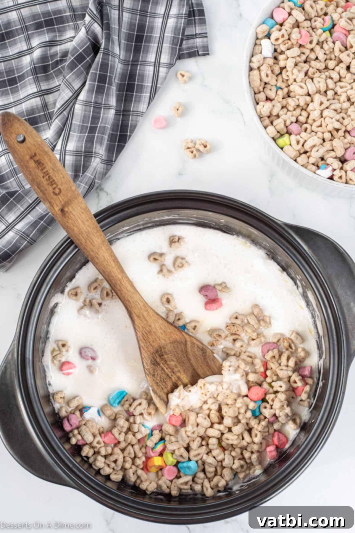 Lucky Charms Treats 5 Lucky Charms cereal being added to the melted marshmallow mixture.