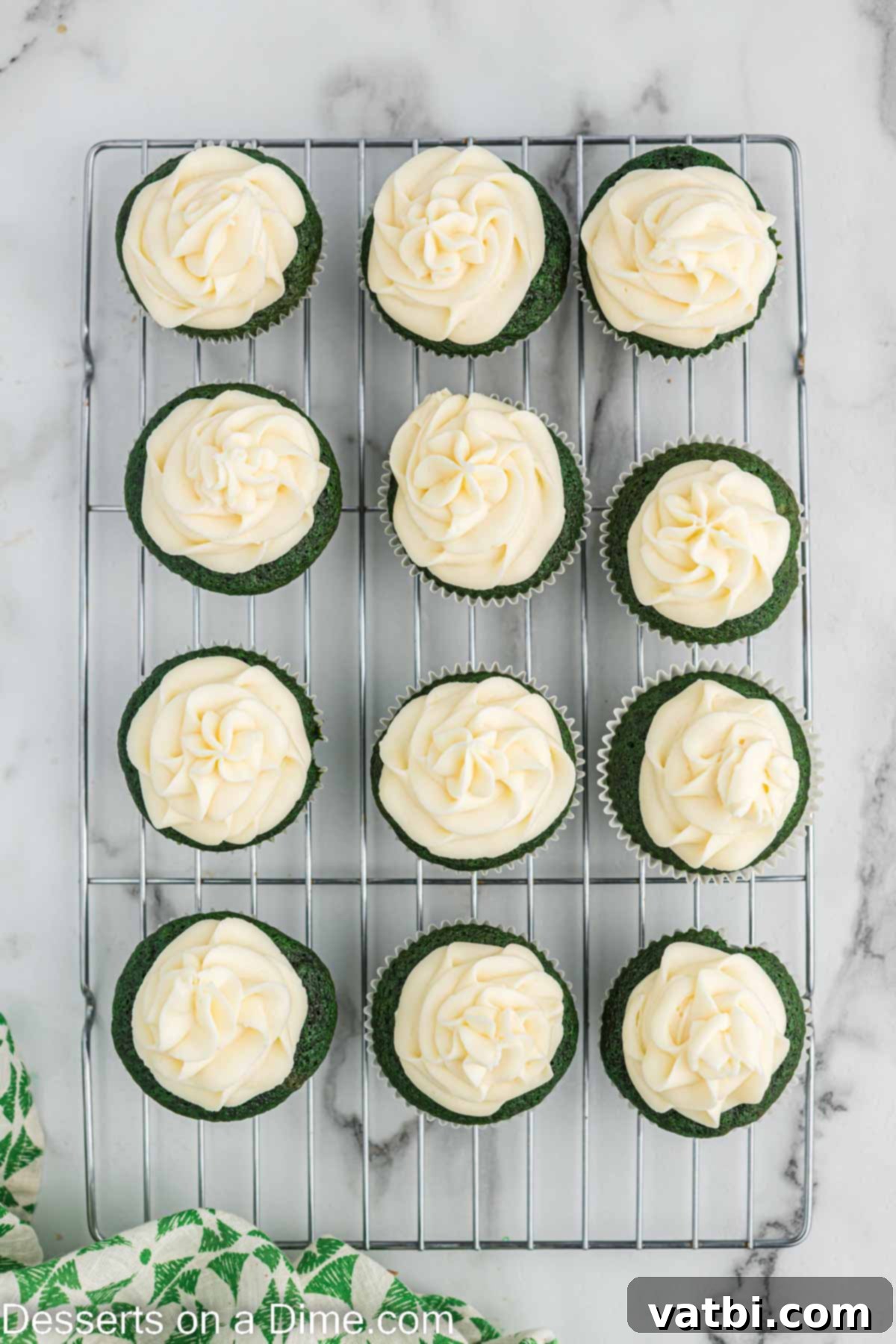 Lush Green Velvet Cupcakes 13 A perfectly frosted green velvet cupcake with a swirl of white cream cheese frosting.