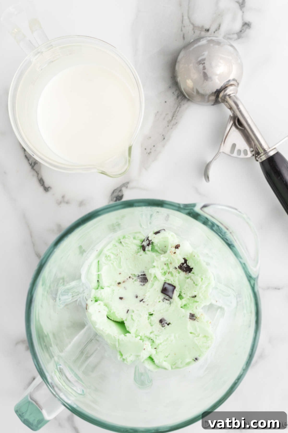 Ultimate Mint Chocolate Chip Milkshake 4 Scoops of mint chocolate chip ice cream and whole milk in a blender.