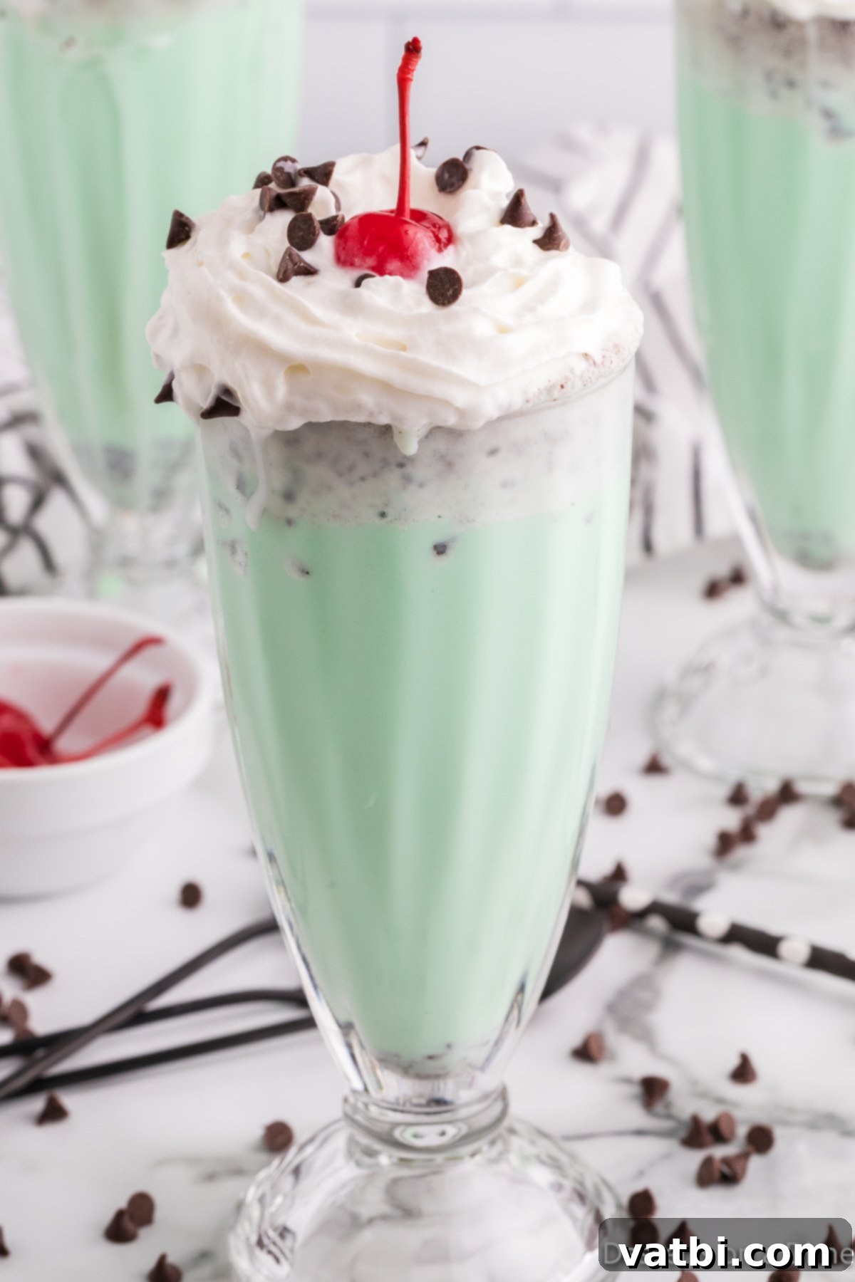 Ultimate Mint Chocolate Chip Milkshake 8 Two glasses of mint chocolate chip milkshakes ready to be enjoyed.