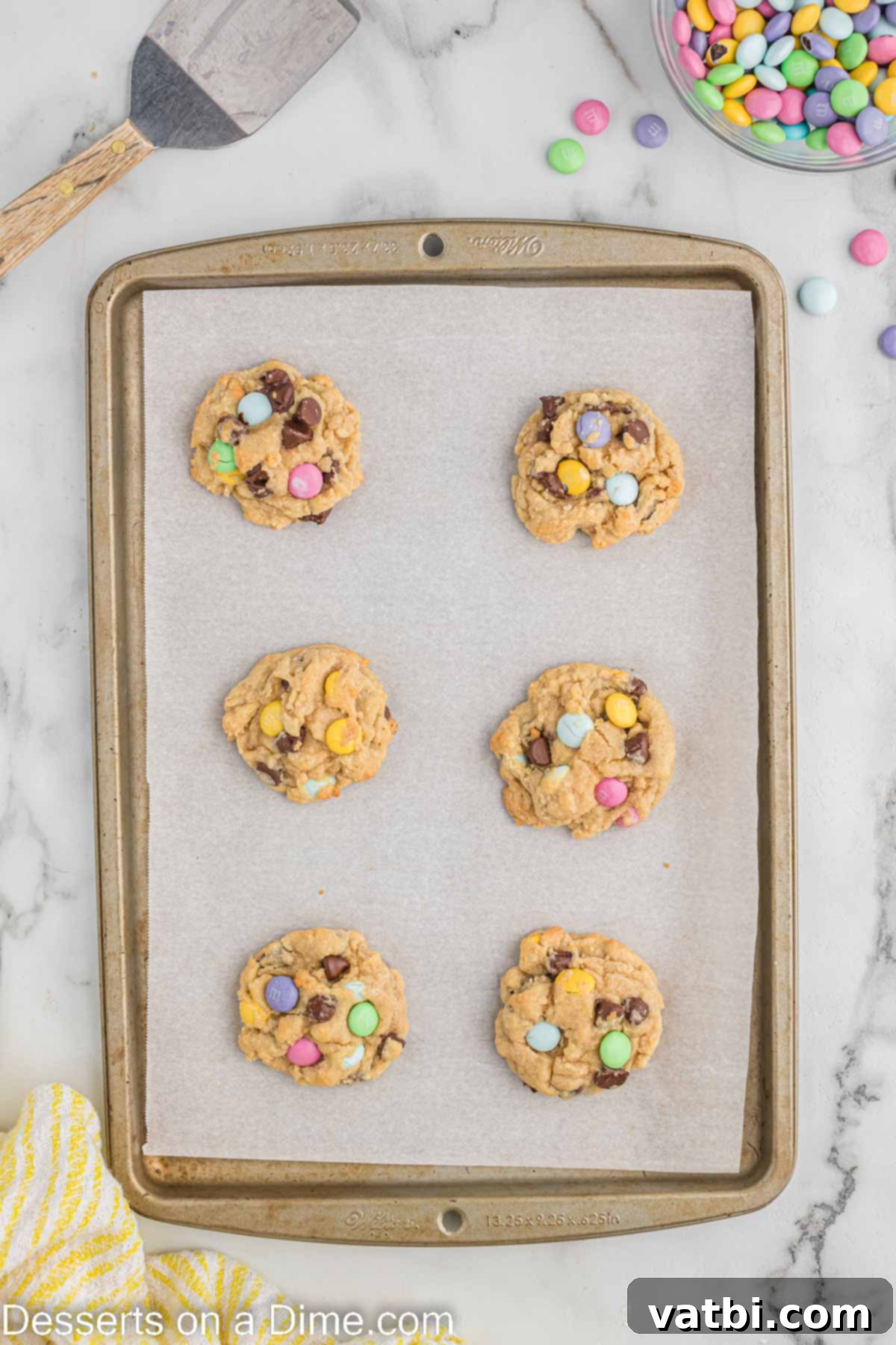 Freshly baked Easter Chocolate Chip Cookies cooling on the baking sheet.