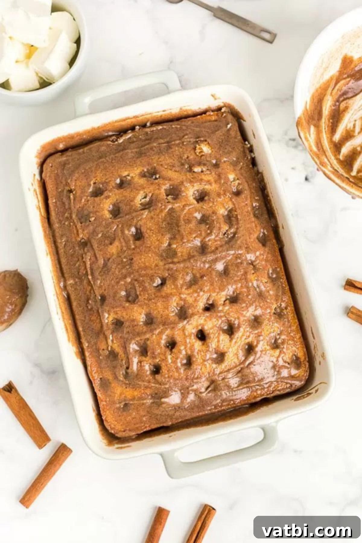 Irresistible Cinnamon Roll Poke Cake 5 The cinnamon roll mixture evenly spread and absorbed into the cake, creating a deliciously moist and flavorful base.