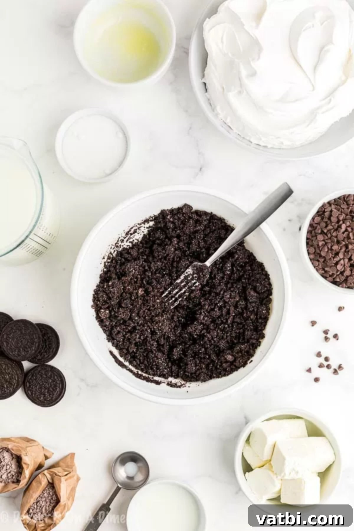 Decadent No-Bake Chocolate Lasagna 2 Crushed Oreo cookies in a bowl with melted butter, ready to be mixed.