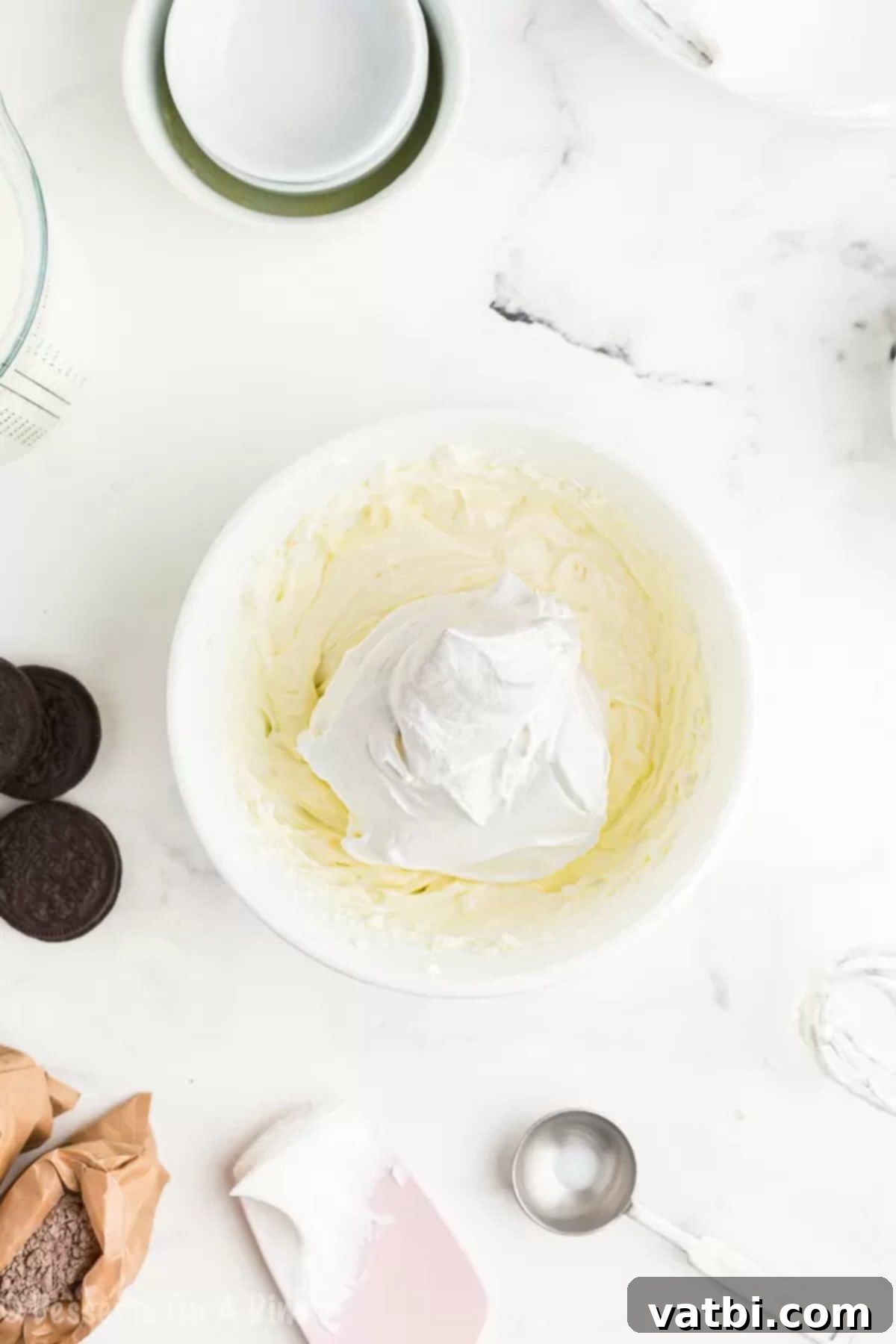 Decadent No-Bake Chocolate Lasagna 3 Cream cheese and pudding mixture combined in a bowl, showing a creamy texture.