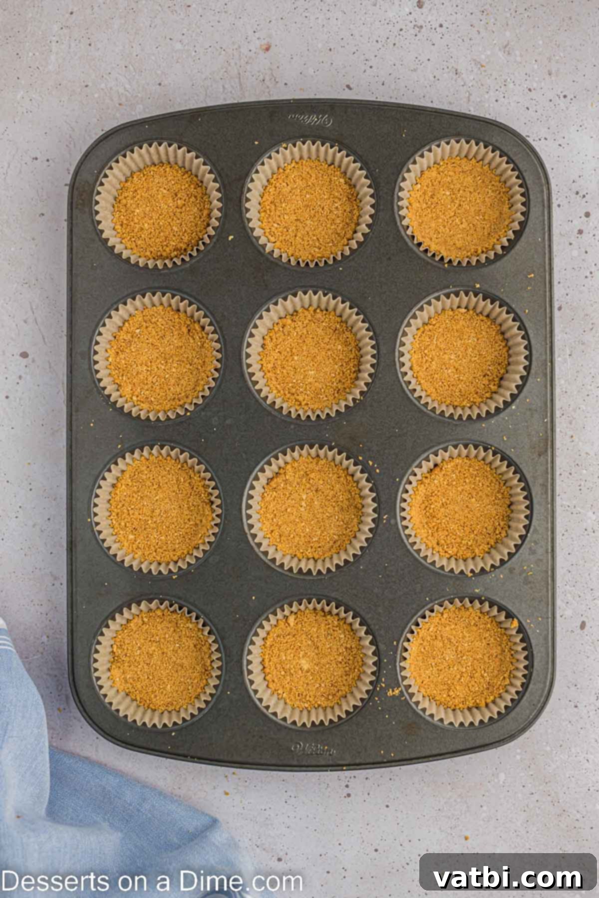Easter Cheesecake Bites 5 Graham cracker crumbs in muffin tin.