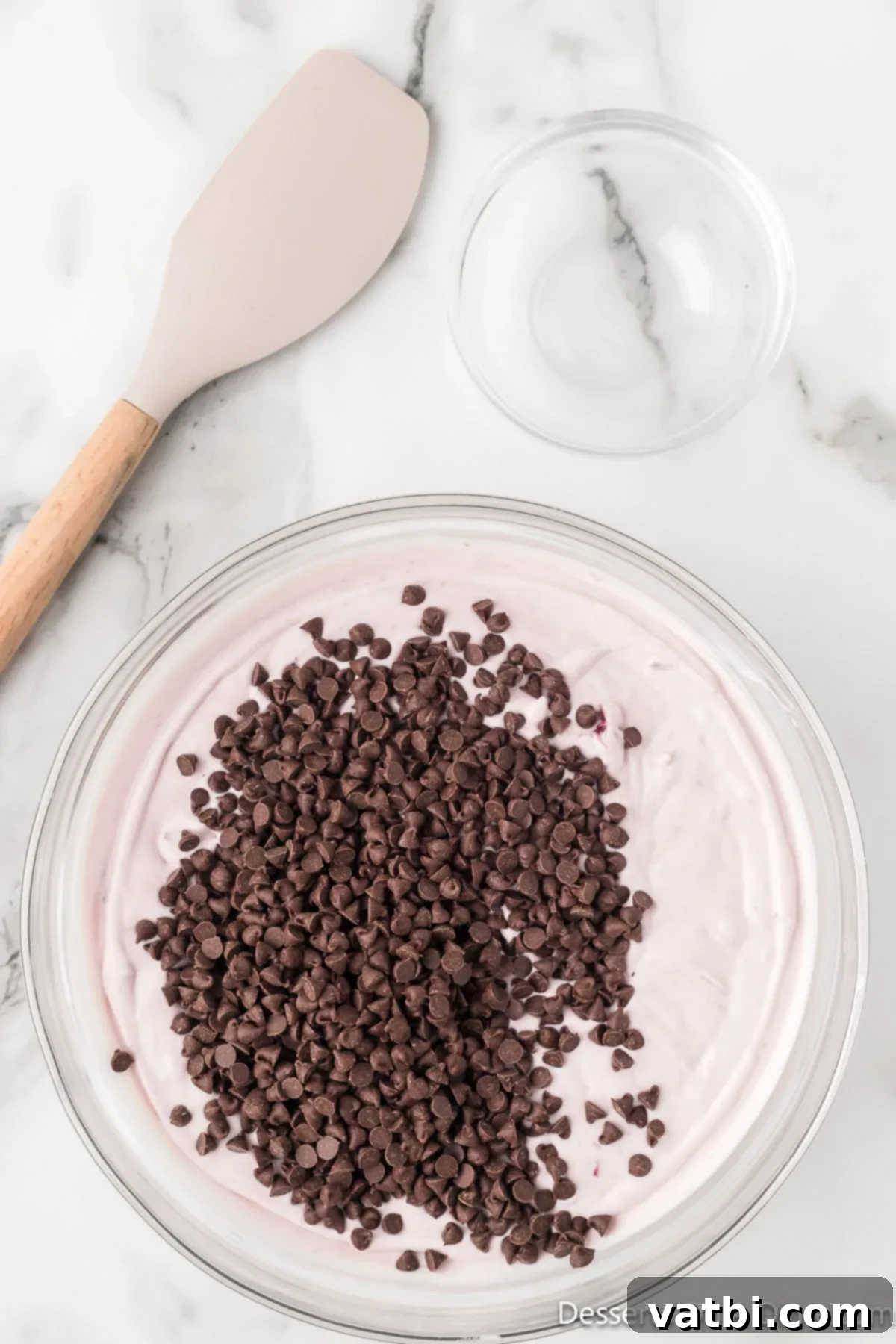 Cherry Chocolate Chip Ice Cream 6 Mini chocolate chips being added to the cherry ice cream base.