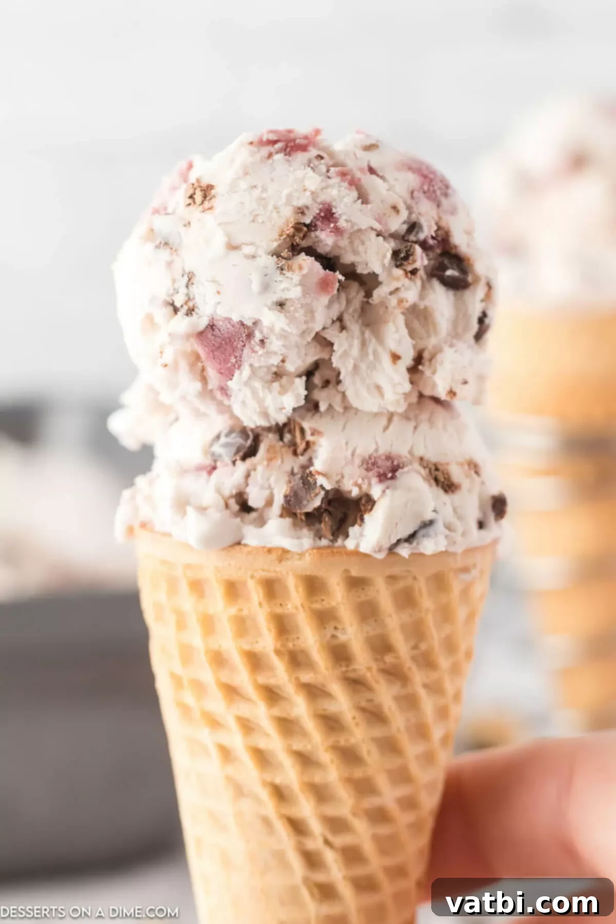 Cherry Chocolate Chip Ice Cream 10 A scoop of homemade cherry chocolate chip ice cream served in a waffle cone.