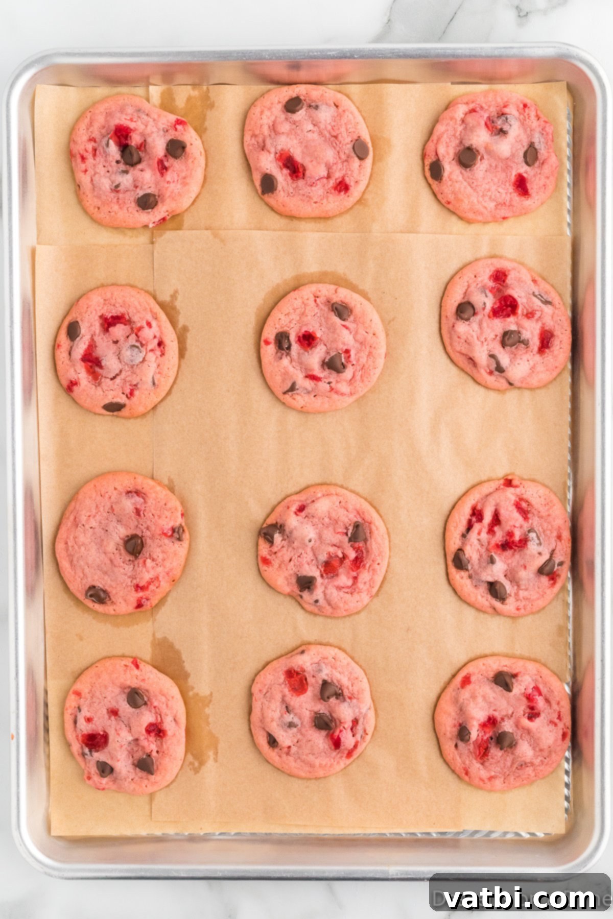 Cookies baked and cooling on baking sheet. 