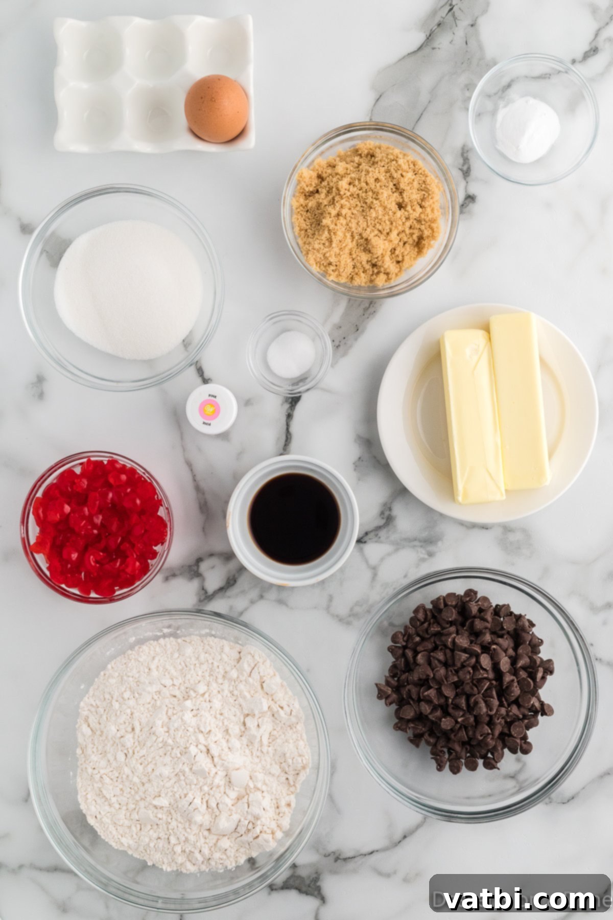 Ingredients for cherry cookies - butter, brown sugar, granulated sugar, eggs, vanilla extract, flour, baking soda, salt, cherries, chocolate chips, pink food coloring. 