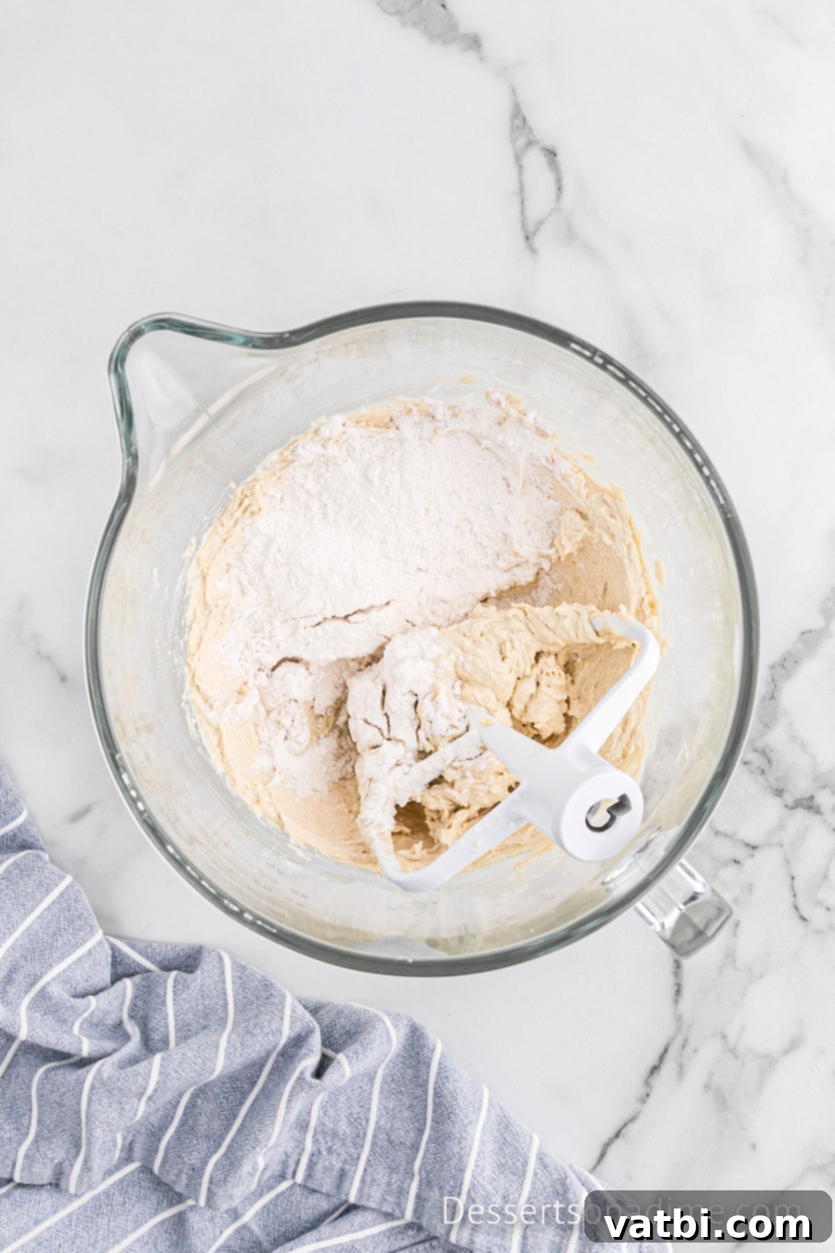 Wet and dry cookie ingredients combined in a mixing bowl.