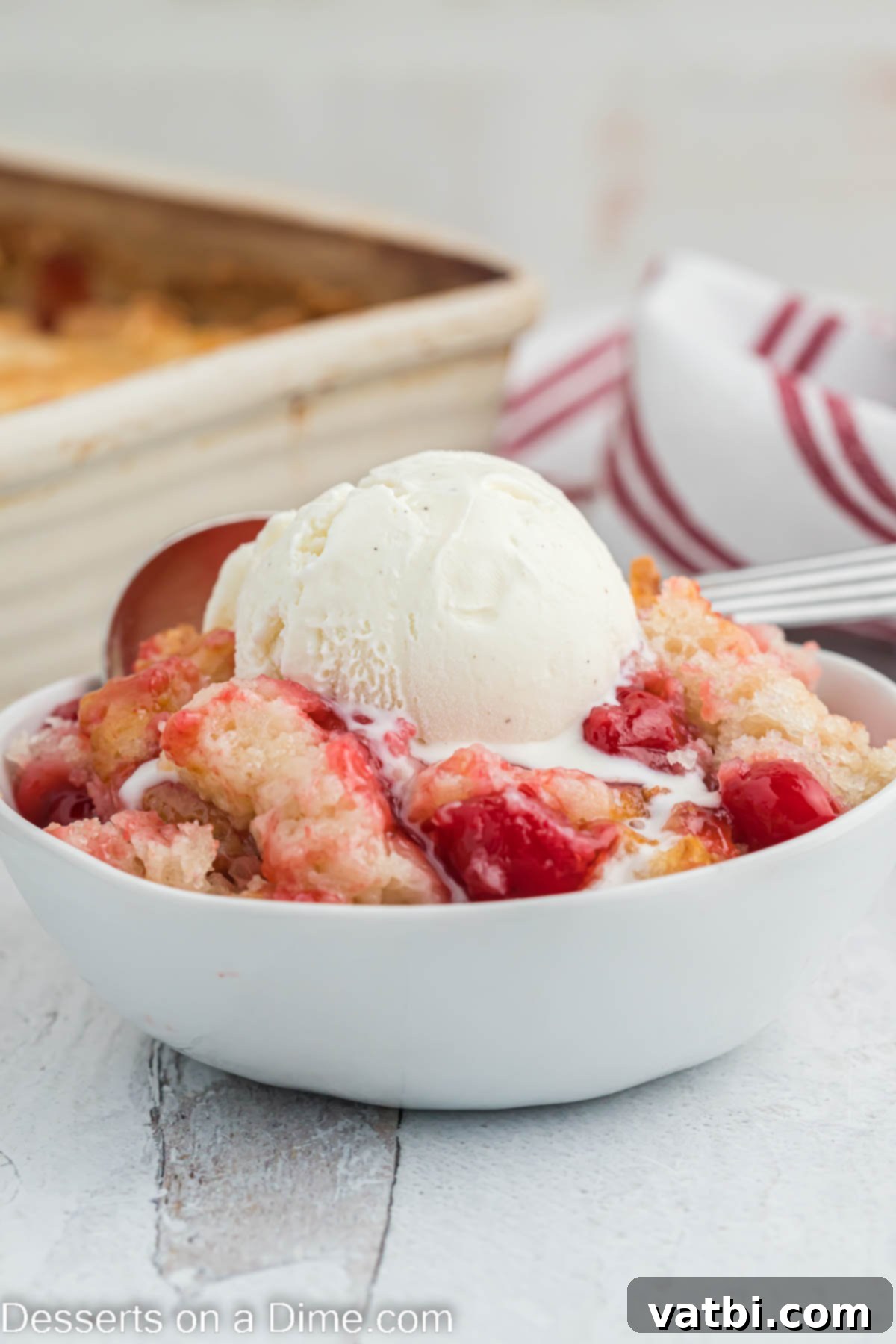 Homemade Cherry Cobbler Bliss 2 Cherry cobbler in a bowl with ice cream.