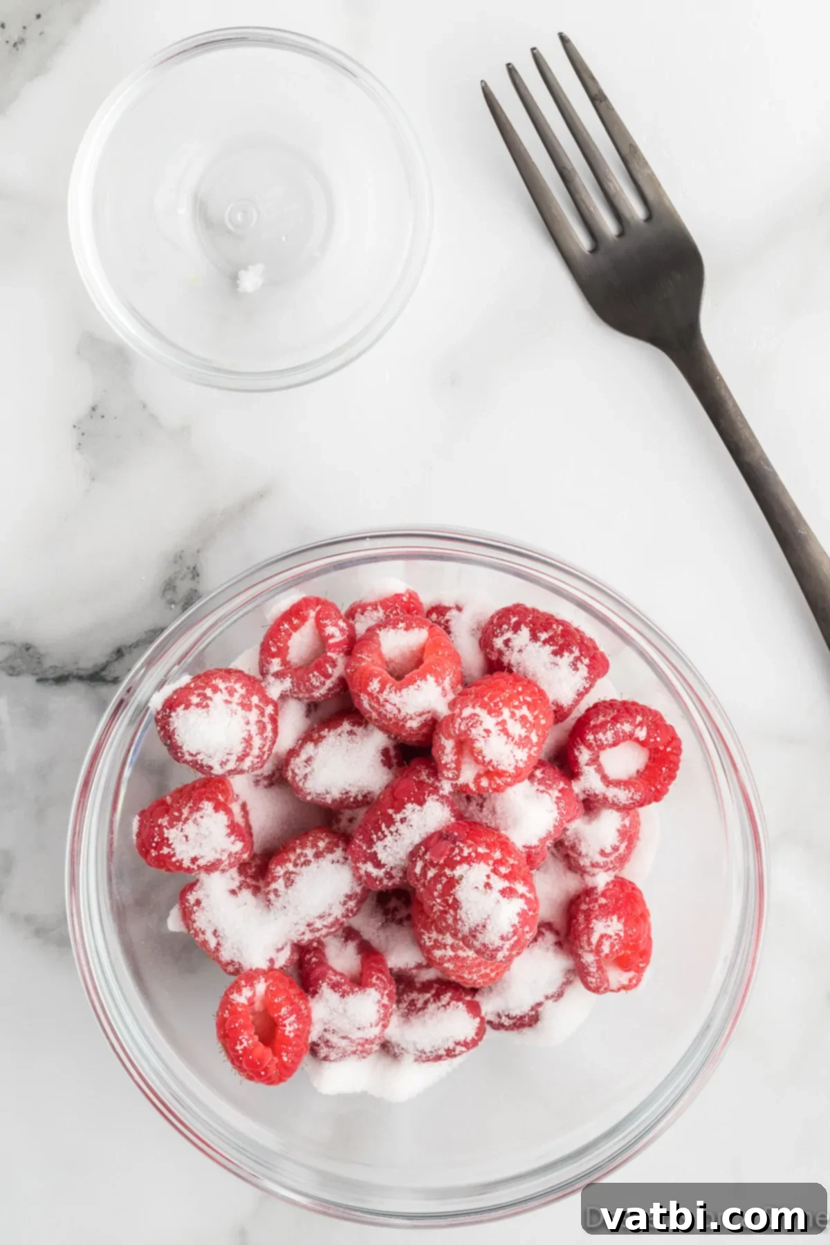 White Chocolate Raspberry Dream 4 Fresh raspberries in a bowl with granulated sugar.