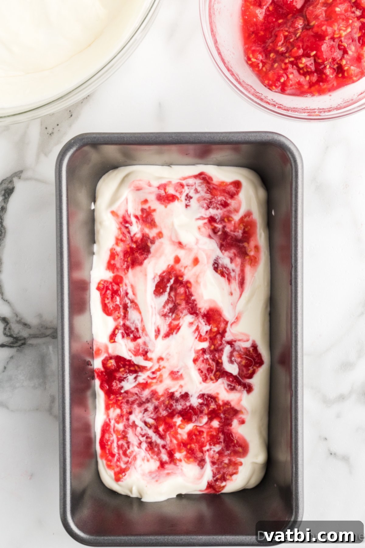 White Chocolate Raspberry Dream 9 Half of the raspberry sauce drizzled over the first layer of ice cream mixture.