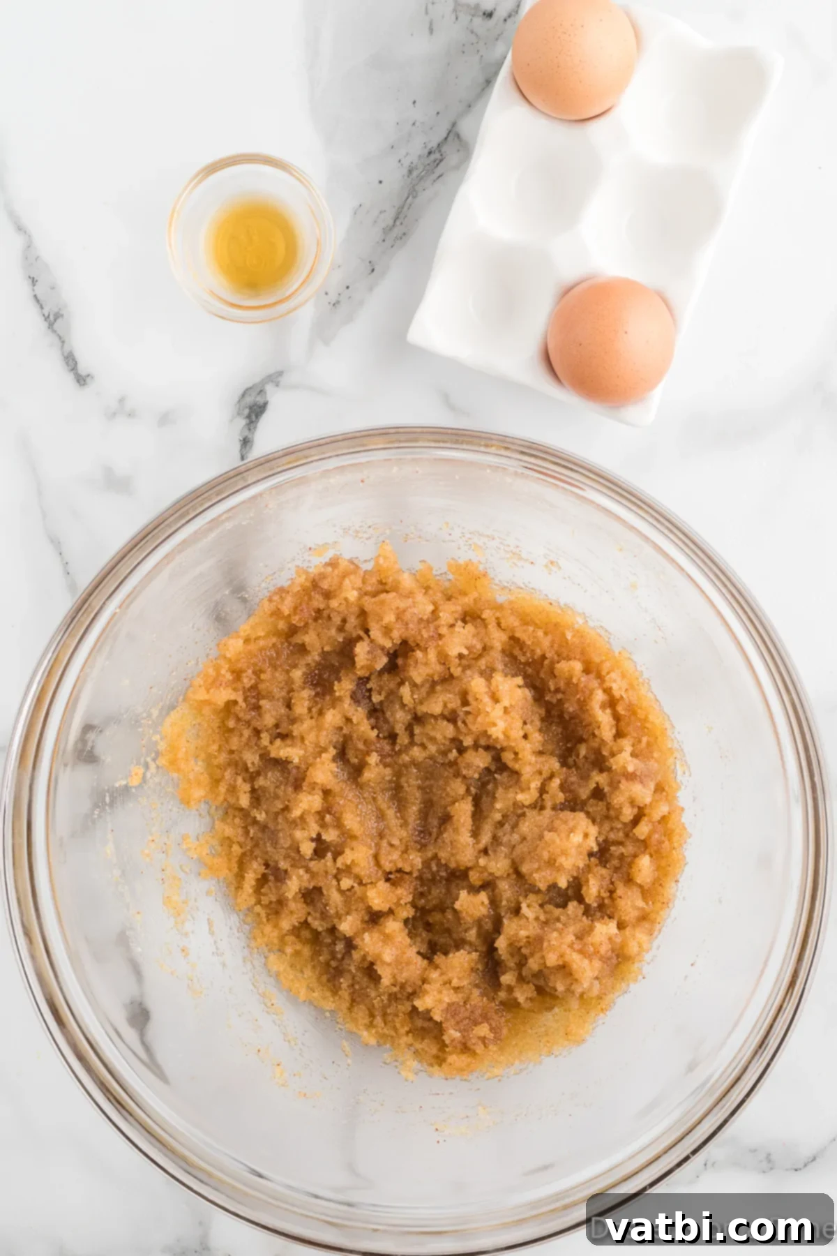 Decadent Nutella Stuffed Cookies 6 Room temperature eggs and sugars being mixed into the cooled browned butter in a large bowl.