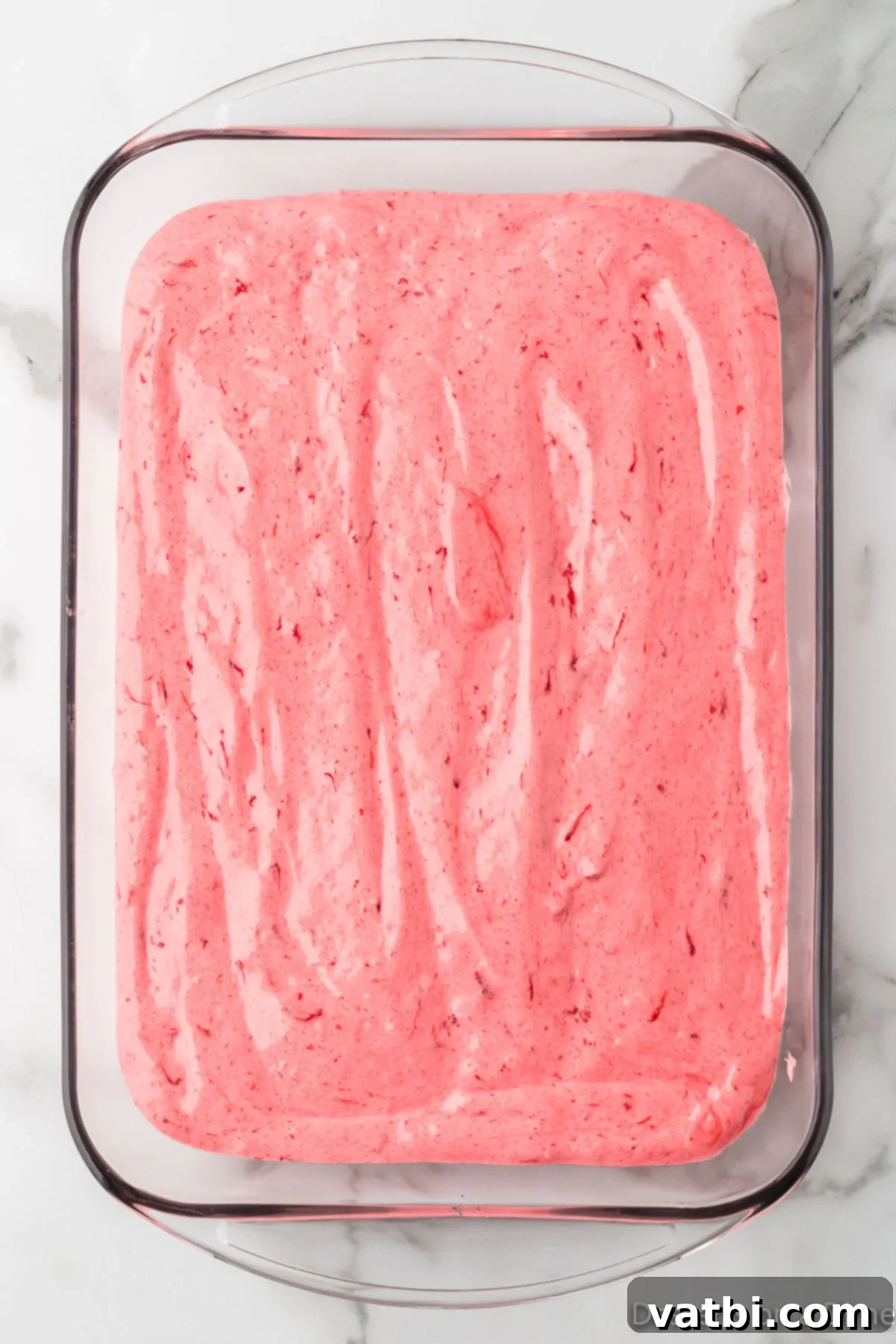 Strawberry Cloud Delight 6 Strawberry Angel Food Cake batter poured into an ungreased 9x13 baking dish, ready for the oven.