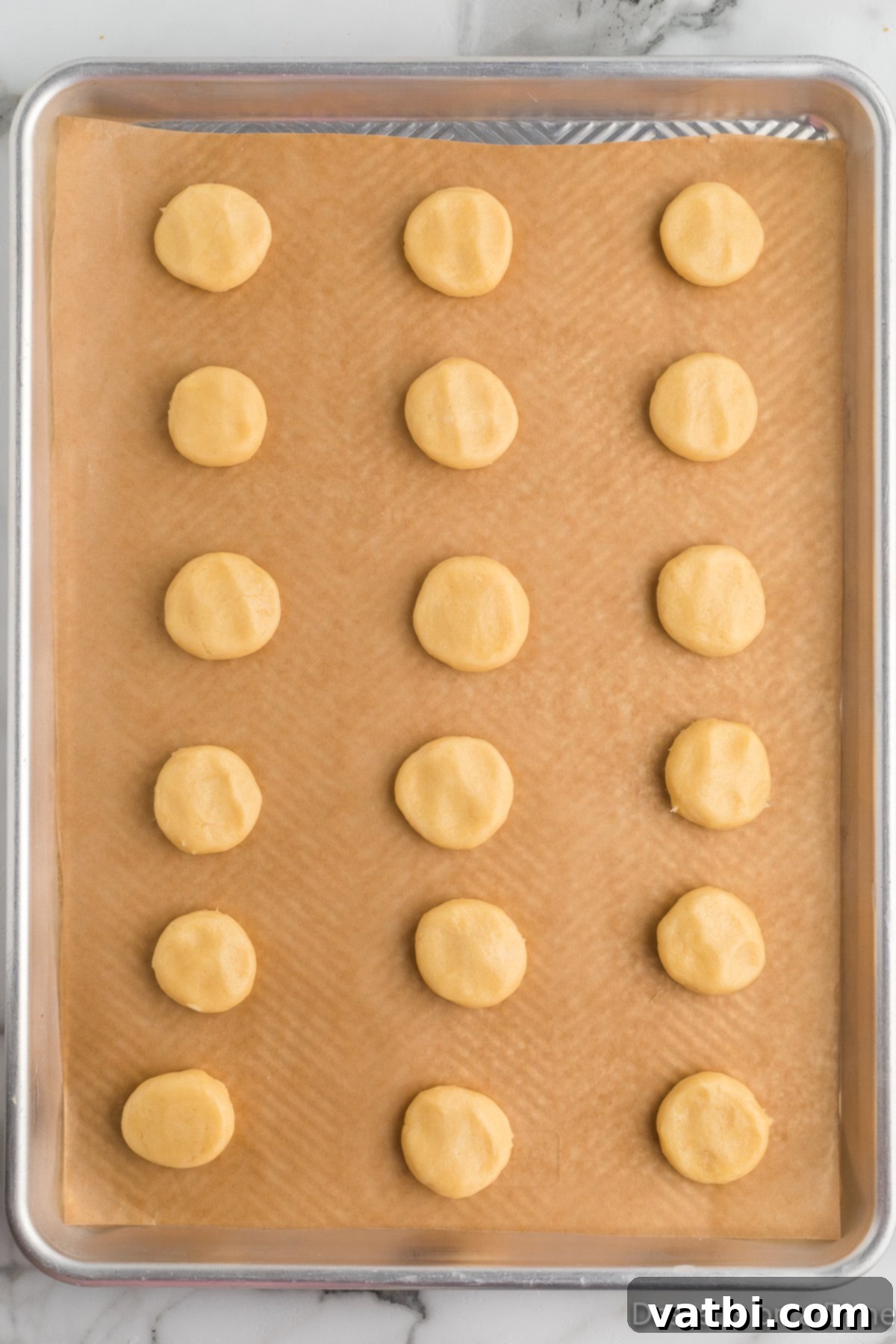 Golden Vanilla Wafer Perfection 10 Cookies flattened on baking sheet.