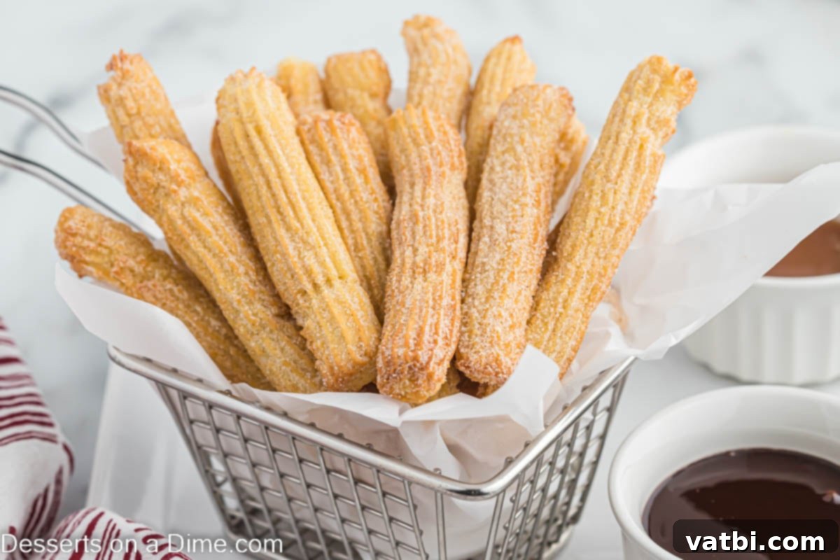 Crispy Air Fryer Churros 2 Golden brown Air Fryer Churros piled high in a rustic basket, ready to be enjoyed.