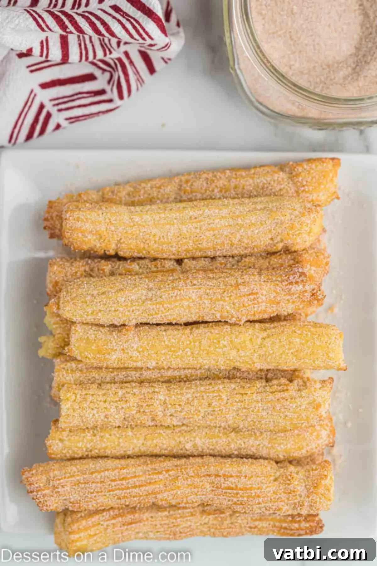 Crispy Air Fryer Churros 11 A beautiful platter of freshly made, cinnamon-sugar-coated Air Fryer Churros, ready to be served and enjoyed.