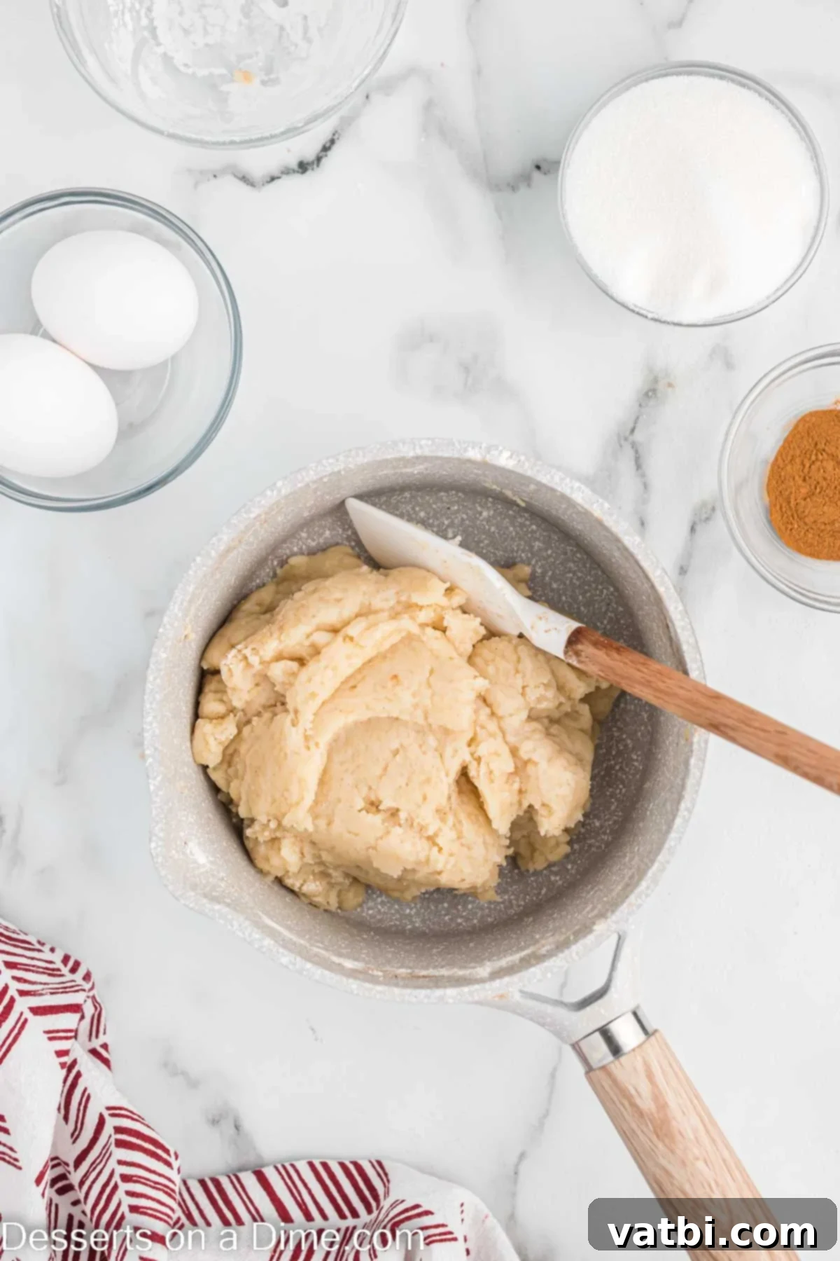 Crispy Air Fryer Churros 5 All-purpose flour being mixed into the hot liquid in a pan, forming a cohesive dough ball.