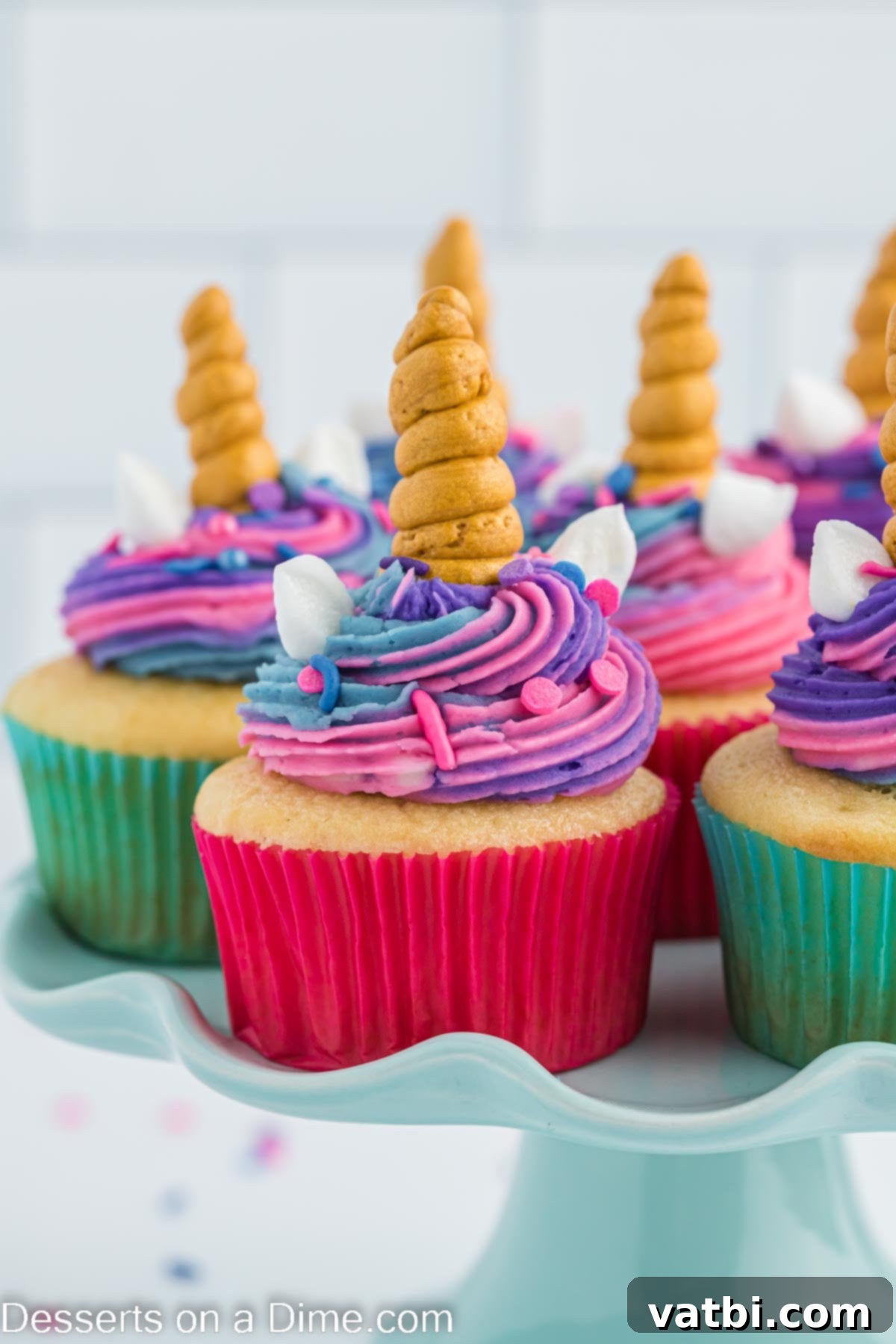 Magical Unicorn Cupcakes 10 Unicorn cupcakes elegantly arranged on a multi-tiered stand, ready for a party.