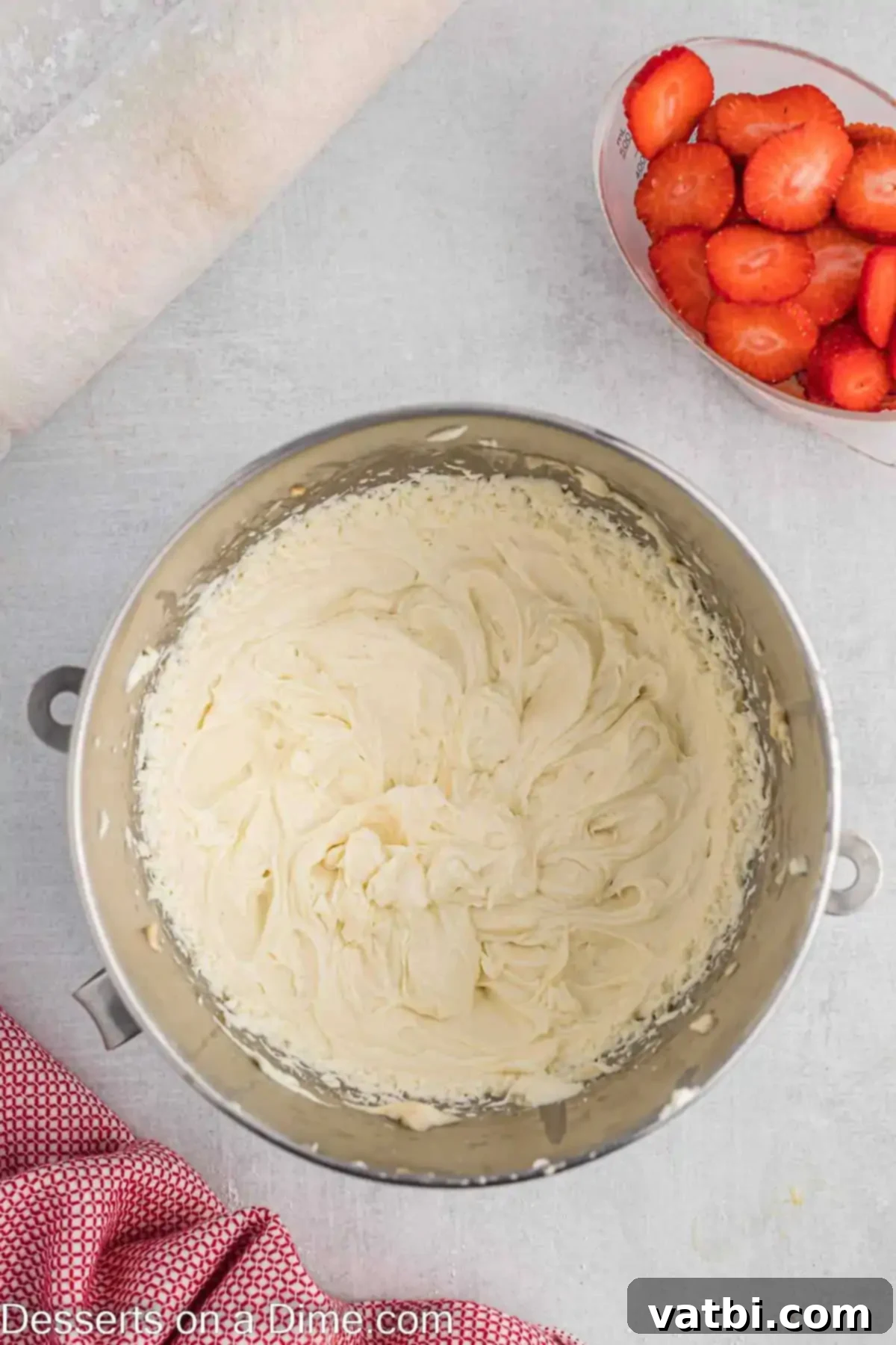 Strawberry Shortcake Swiss Roll 9 Whipping cream added to mixture in bowl.