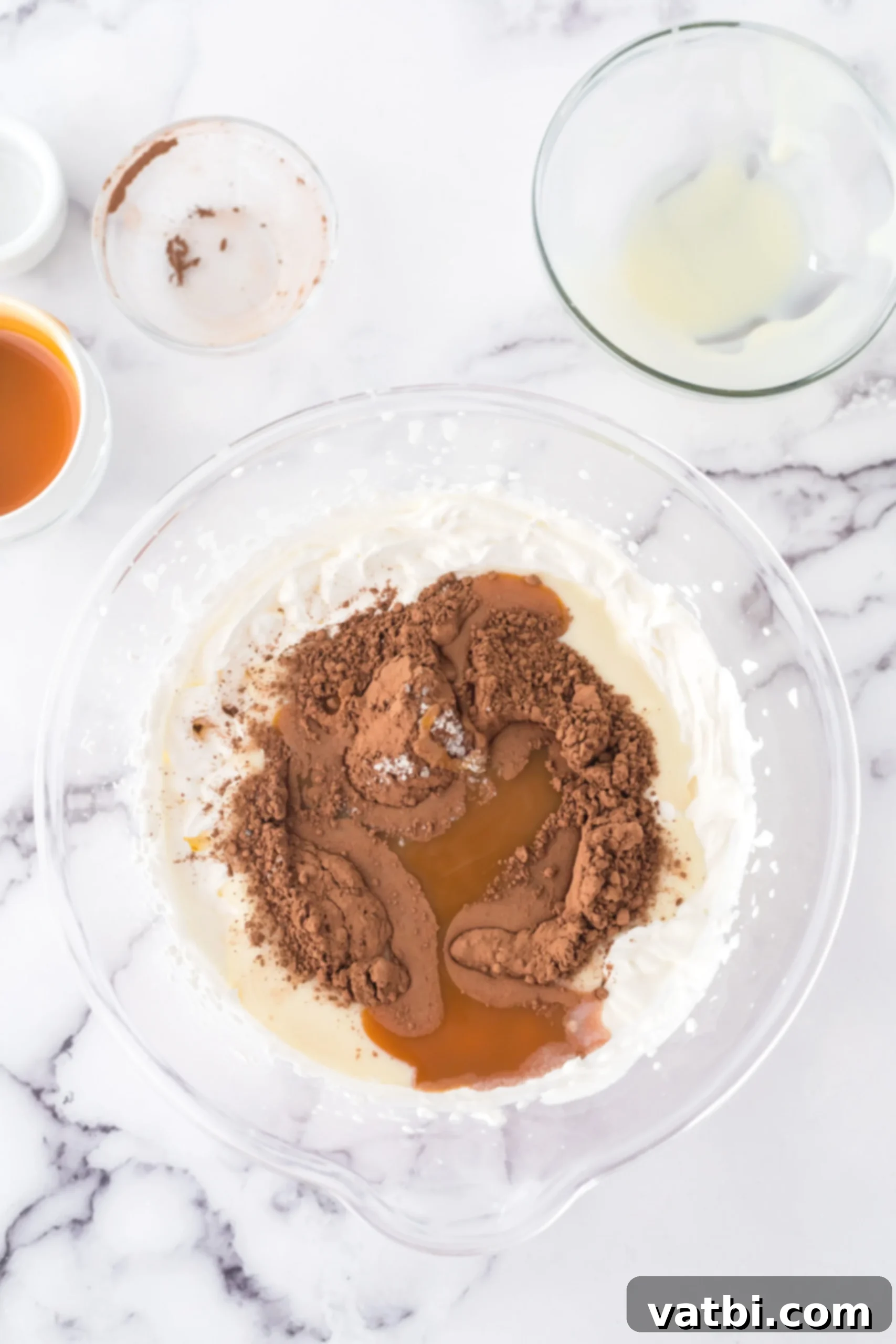 Cocoa powder and other ingredients mixed into bowl. 