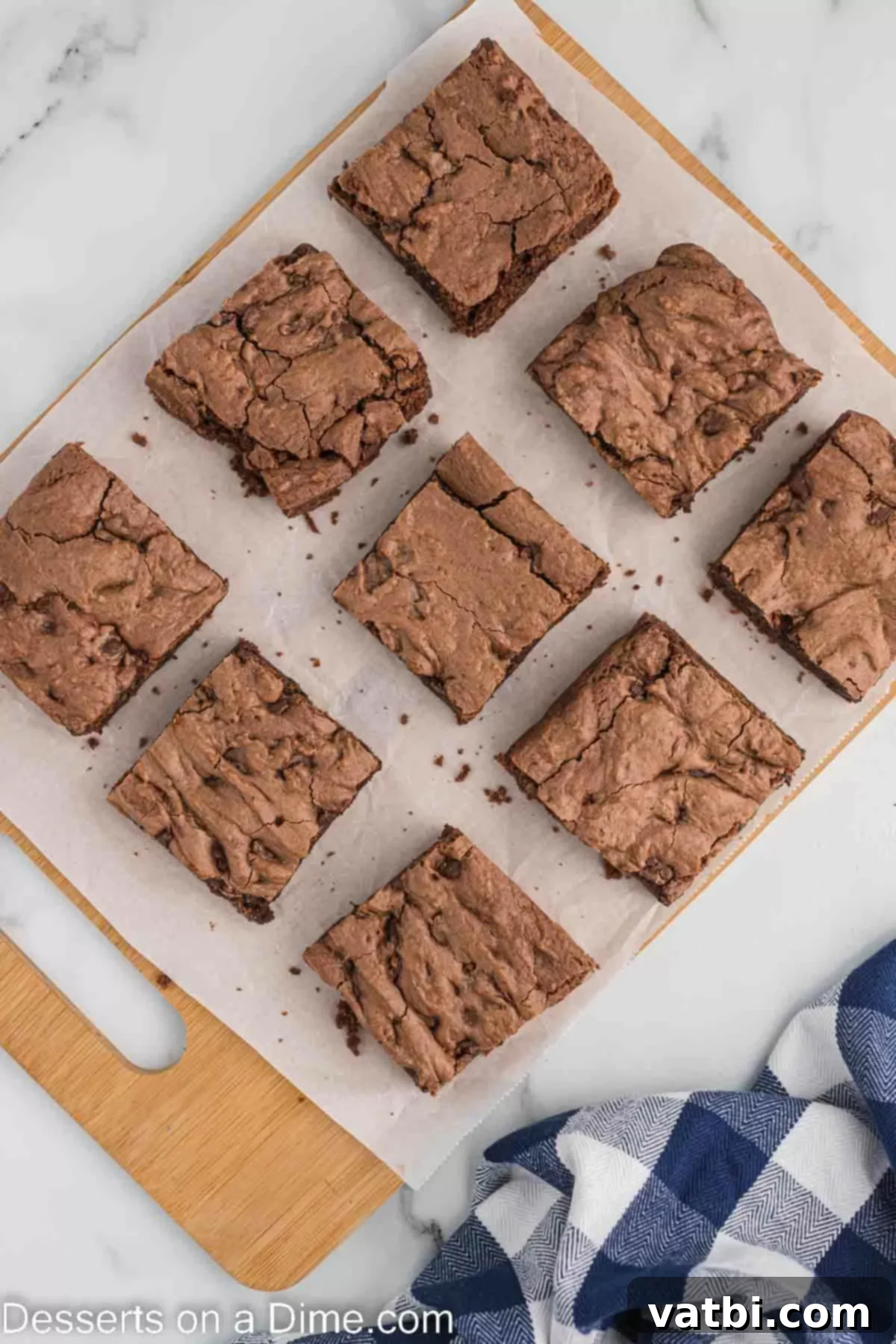 Closeup of fudgy cake mix brownies cut into perfect squares on a white surface, ready to be served.