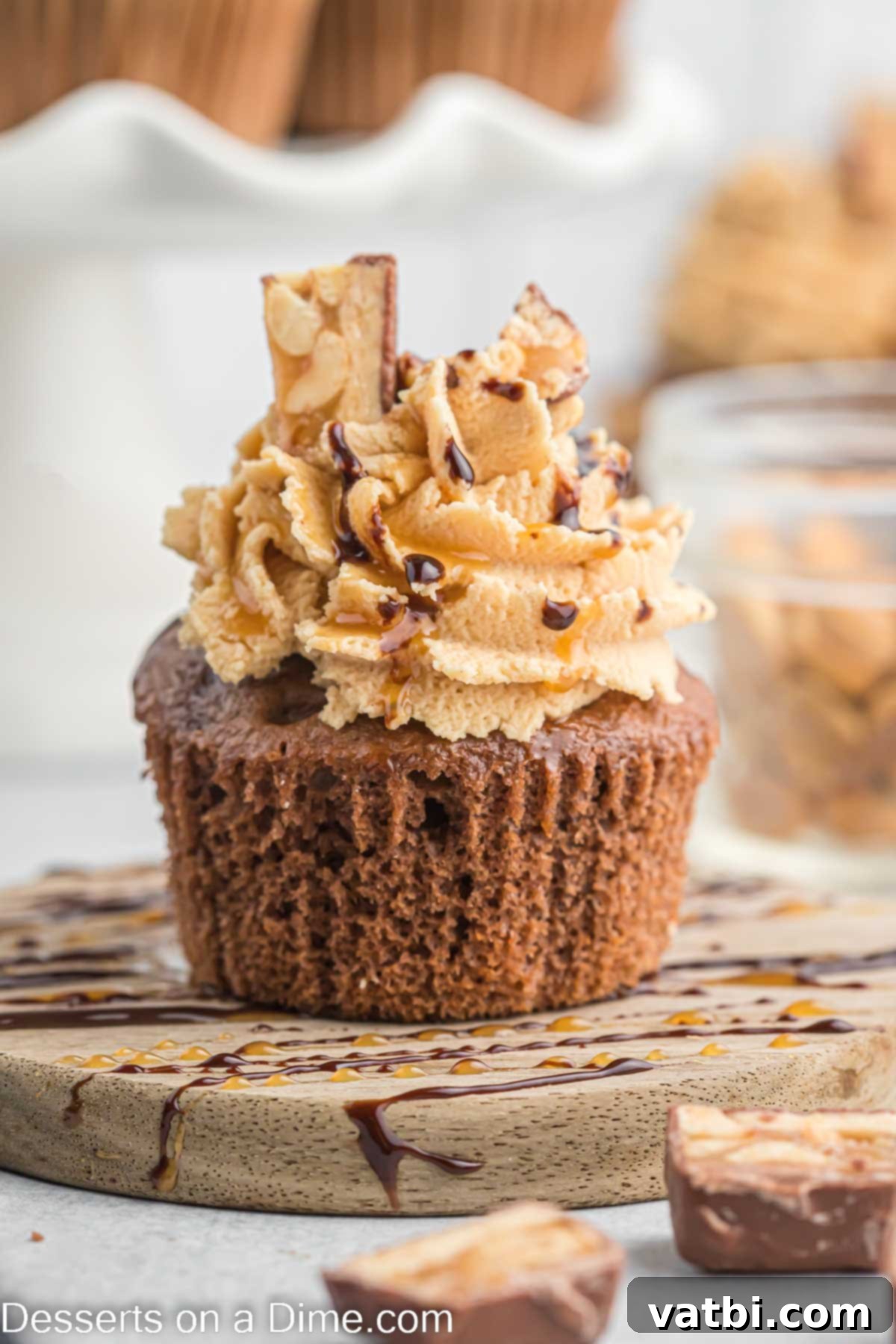 Ultimate Snickers Cupcakes 11 Cupcake drizzled with caramel and chocolate.