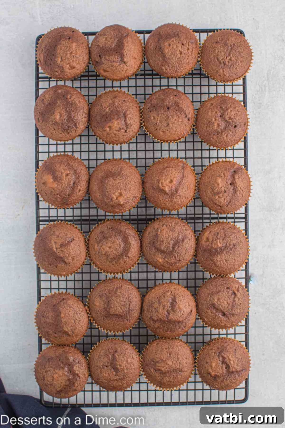 Ultimate Snickers Cupcakes 4 Cupcakes on wire rack cooling.